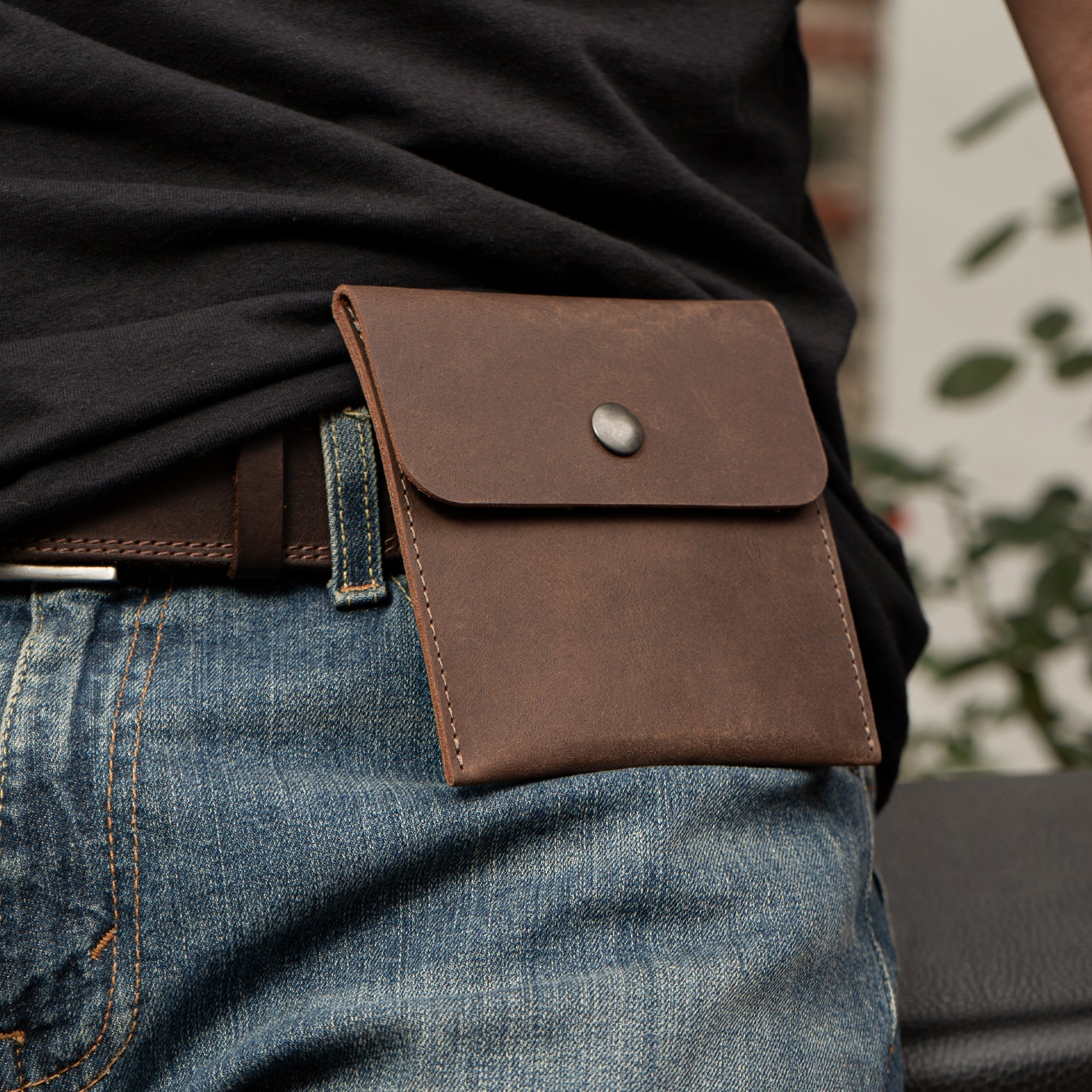 The Hide & Ride Document Handlebar Bag secured on a rider's belt, illustrating its versatility as a small bag for handlebar and personal storage. This Motorcycle Document Bag is made of full grain leather, designed for bikers who appreciate quality and craftsmanship from StockyardX.