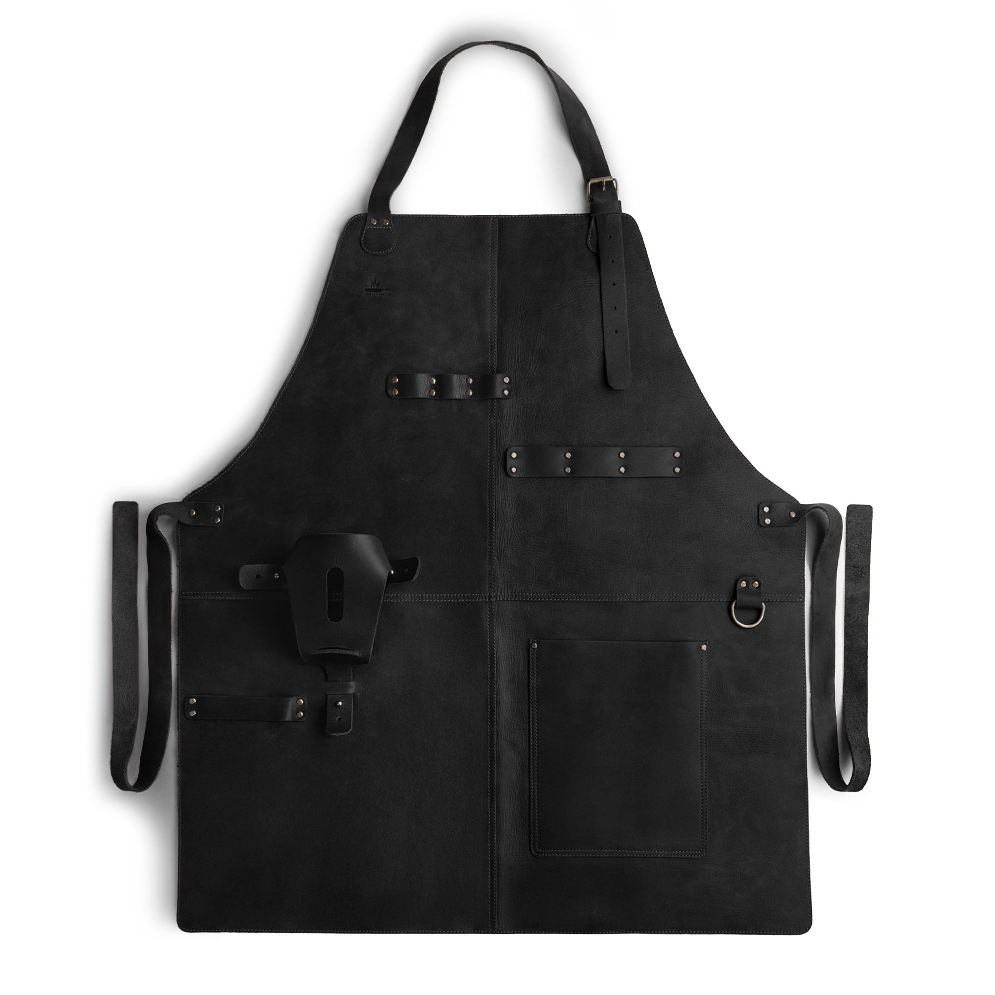 Stylish detail of Cast Leather Co. BBQ Apron, featuring pockets and tools in black leather. This rustic apron is perfect for cooking, made from durable full grain leather and embodies the handmade artisan spirit from La Antigua Guatemala & Oaxaca Mexico.