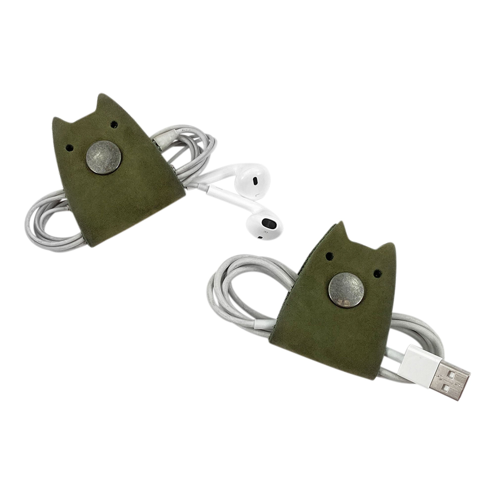 Green Taco Dog Cat Cord Keeper (2 Pack) featuring a paw print design, perfect for keeping your cables organized. Crafted from full grain leather, these practical accessories clip together for easy travel management. Handmade by artisans in La Antigua Guatemala & Oaxaca Mexico.