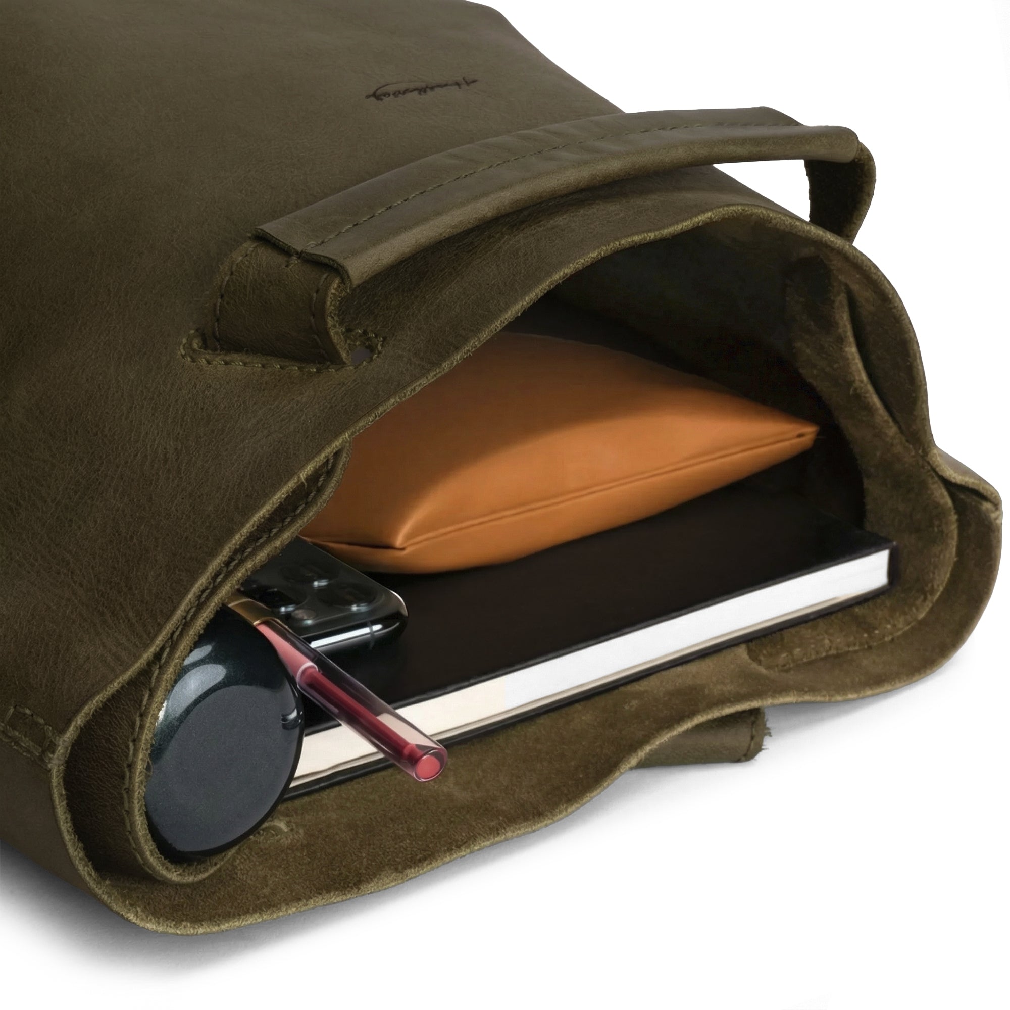 An open view of the Convertible Backpack to Shoulder Bag by Heather's reveals ample storage for daily essentials. This spacious crossbody for women is crafted from high-quality full grain leather, reflecting the values of small batch production and artisan craftsmanship. Handmade in La Antigua Guatemala & Oaxaca Mexico, each bag is uniquely hand cut, hand sewn, and fire branded.