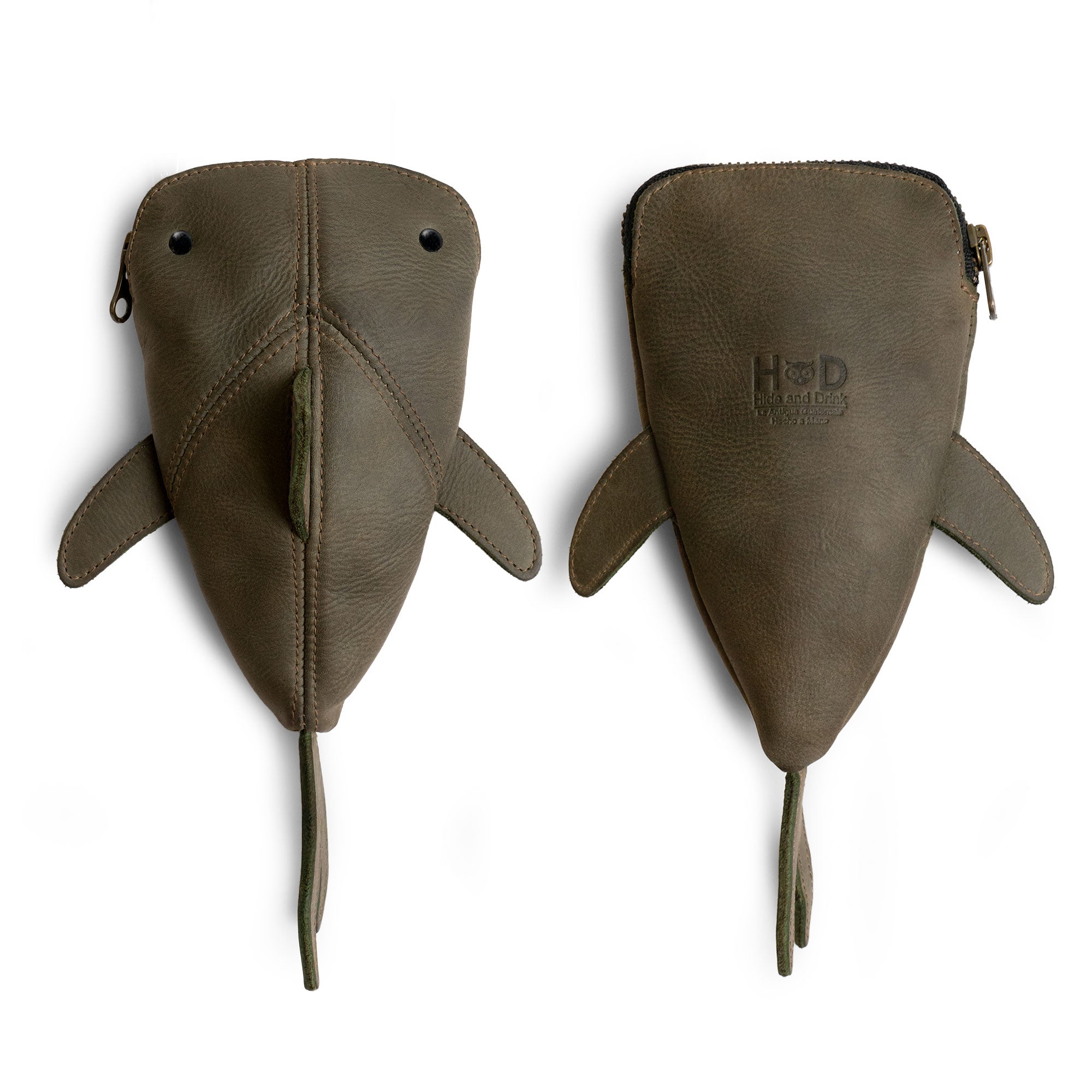 The green Leather Shark Pouch by Hide & Drink, showing its playful design and zippered closure. This unique case is perfect for organize pens and art supplies, serving as a shark shaped pencil purse or cable holder. Each pouch is handcrafted from full grain leather in La Antigua Guatemala & Oaxaca Mexico.