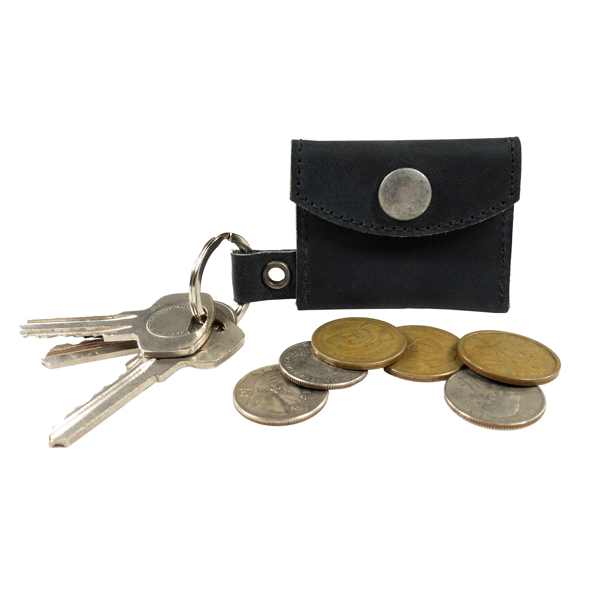 Tiny Coin Holder Keychain by Hide & Drink, with coins and keys, highlighting its functionality and elegant design. This Full Grain Leather accessory symbolizes small batch production and artisan craftsmanship from La Antigua Guatemala.