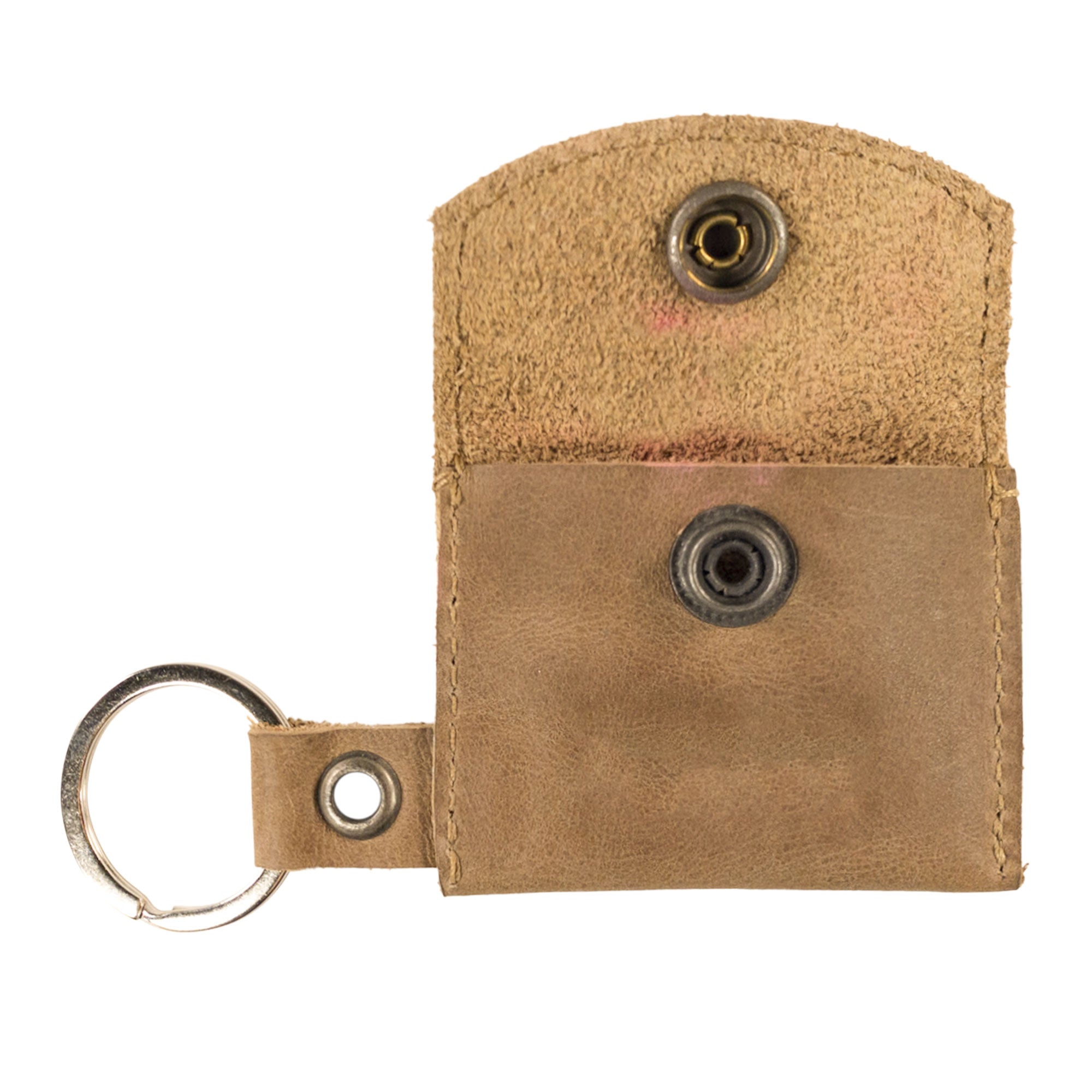 A close-up view of the Tiny Coin Holder Keychain by Hide & Drink, flaunting its robust Full Grain Leather and button closure for secure storage. This Tiny Coin Holder reflects small batch production artistry from La Antigua Guatemala.
