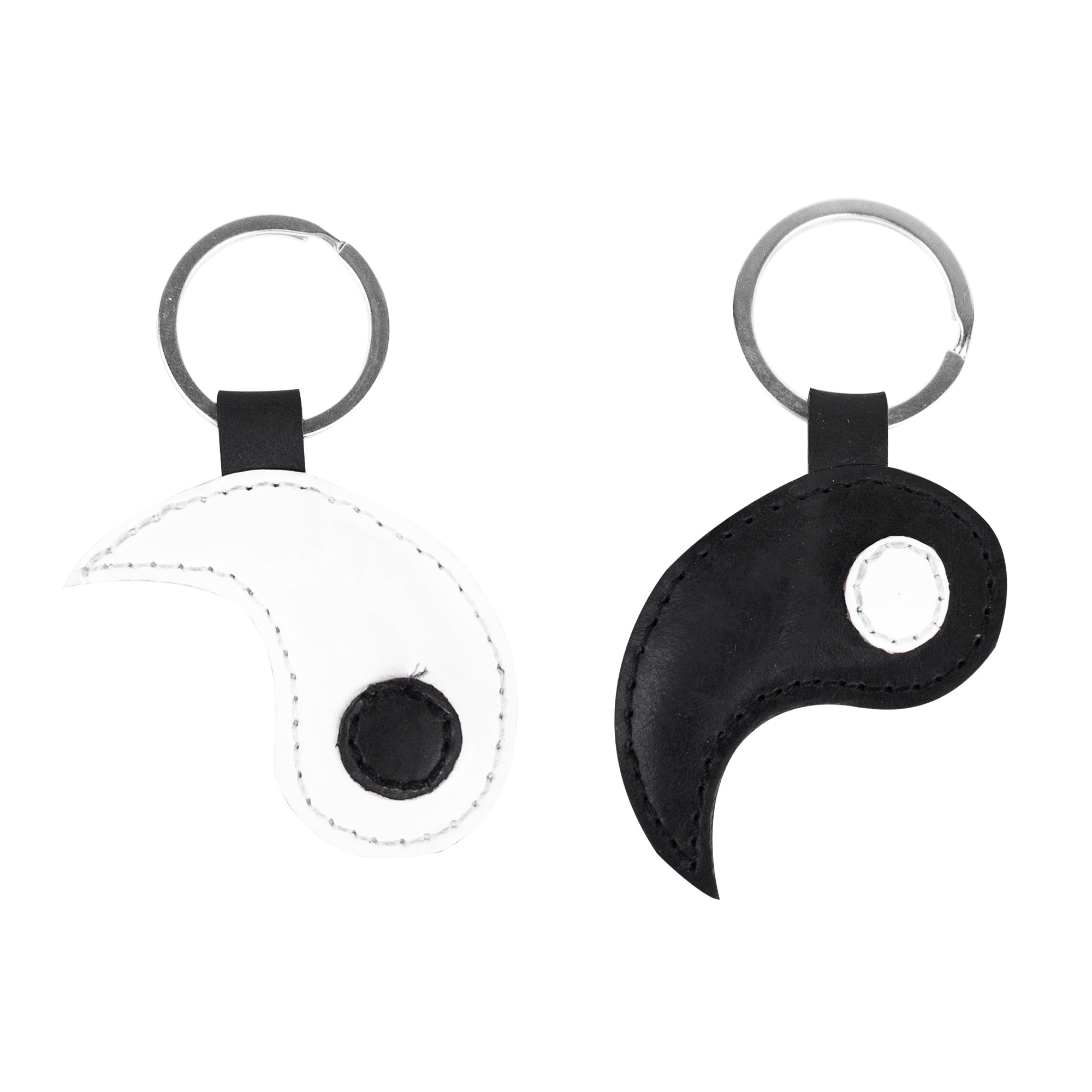 A pair of Yin Yang Keychains (2 pieces) from Hide & Drink, highlighted with two distinct key rings that signify duality and togetherness. Made from premium full grain leather, these keychains celebrate Chinese culture and friendship. Enjoy the artisanal touch through small batch production, with each piece being hand cut, hand sewn, and fire branded for durability. Crafted in La Antigua Guatemala & Oaxaca Mexico.