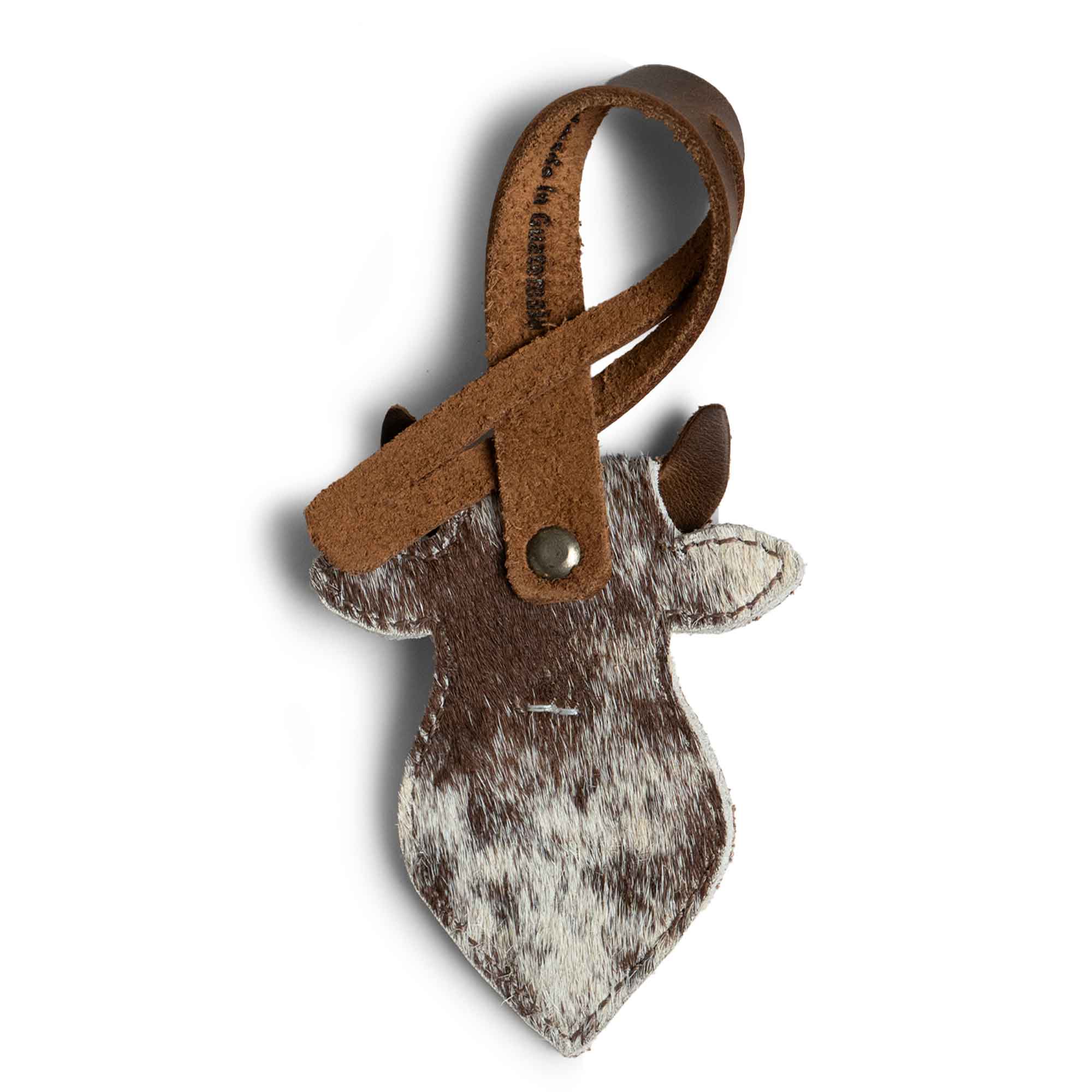 Hide & Drink Bag Charms displaying a delightful cow head design, ideal charm for handbags. This charming accessory acts as a purse charm for tote & backpacks, crafted from premium full grain leather. Each piece showcases StockyardX's small batch production method with hand cut, hand sewn elements, featuring fire branding for an artisan finish, handmade in La Antigua Guatemala & Oaxaca Mexico.