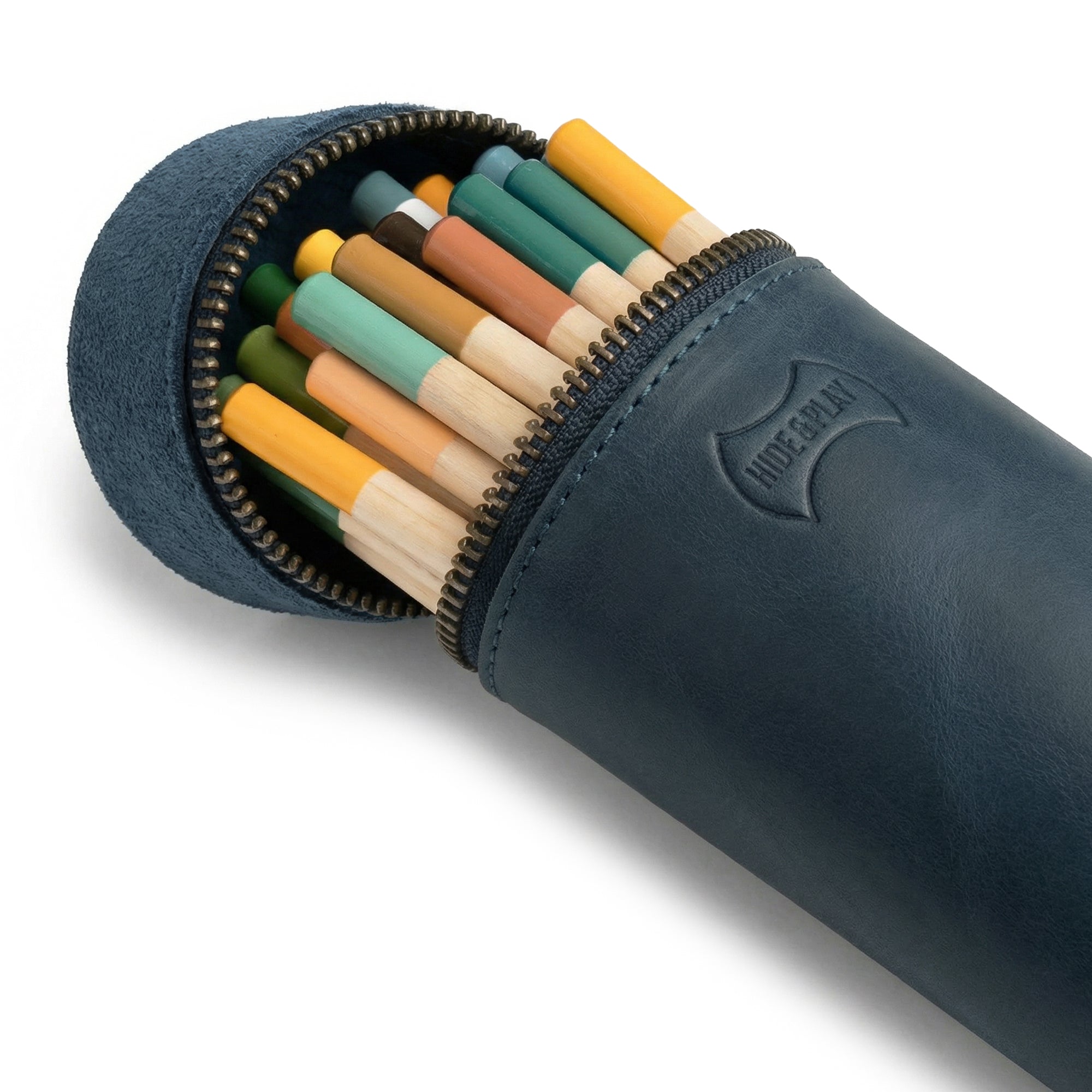 Close-up of the Pencil-Shaped Case by Hide & Play filled with colorful writing instruments, perfect for pens, pencils, markers, and office accessories. The zippered bag is crafted from full grain leather, reflecting artisan skills through small batch production, hand cut, hand sewn, and fire branded methods. Handmade in La Antigua Guatemala.