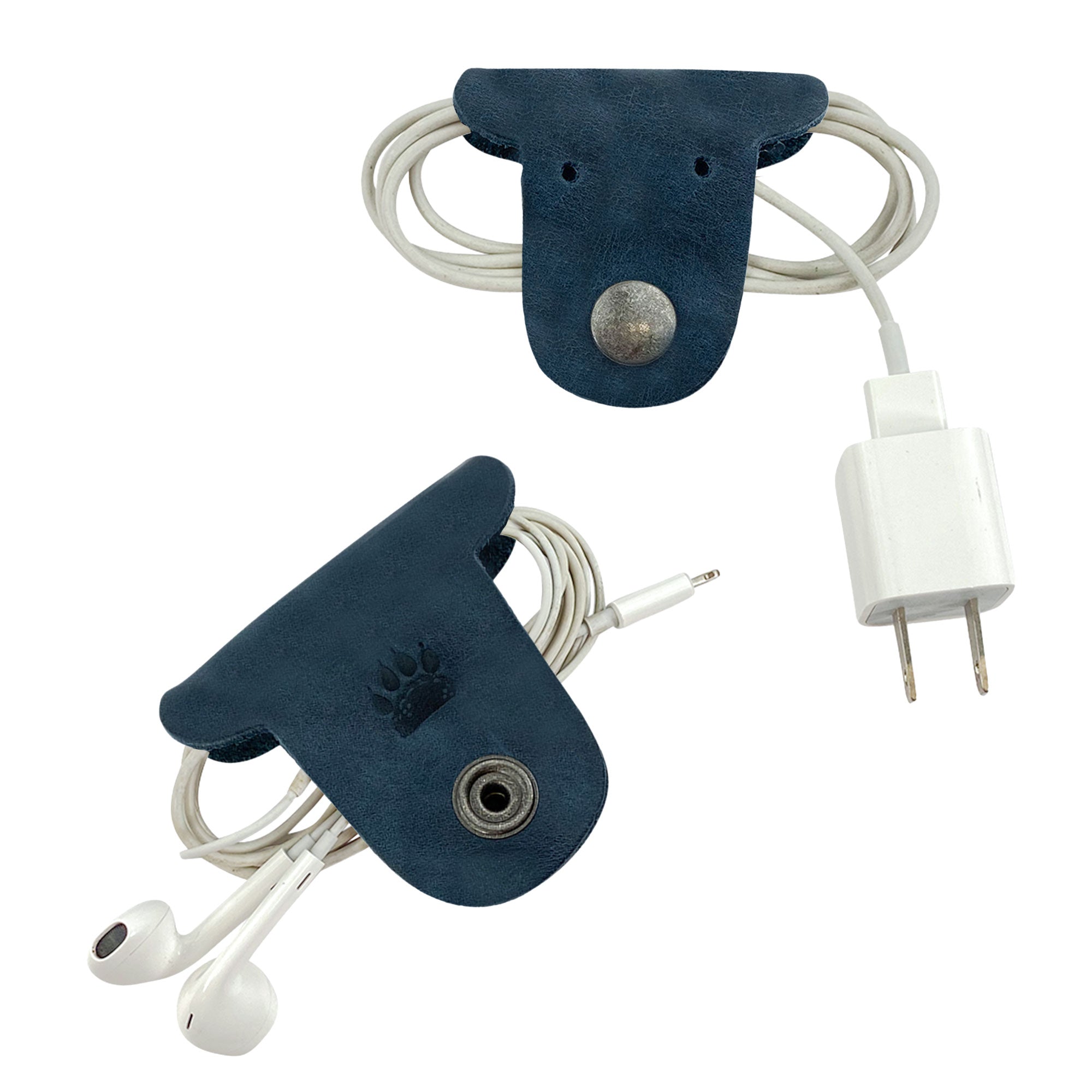 Stay organized while on-the-go with Taco Dog's Dog Cord Keepers, featuring a unique navy blue design for easy wrapping of cables. Made from full grain leather, these handmade accessories offer a stylish solution for managing your earbuds and chargers. Discover artisan craftsmanship from La Antigua Guatemala.