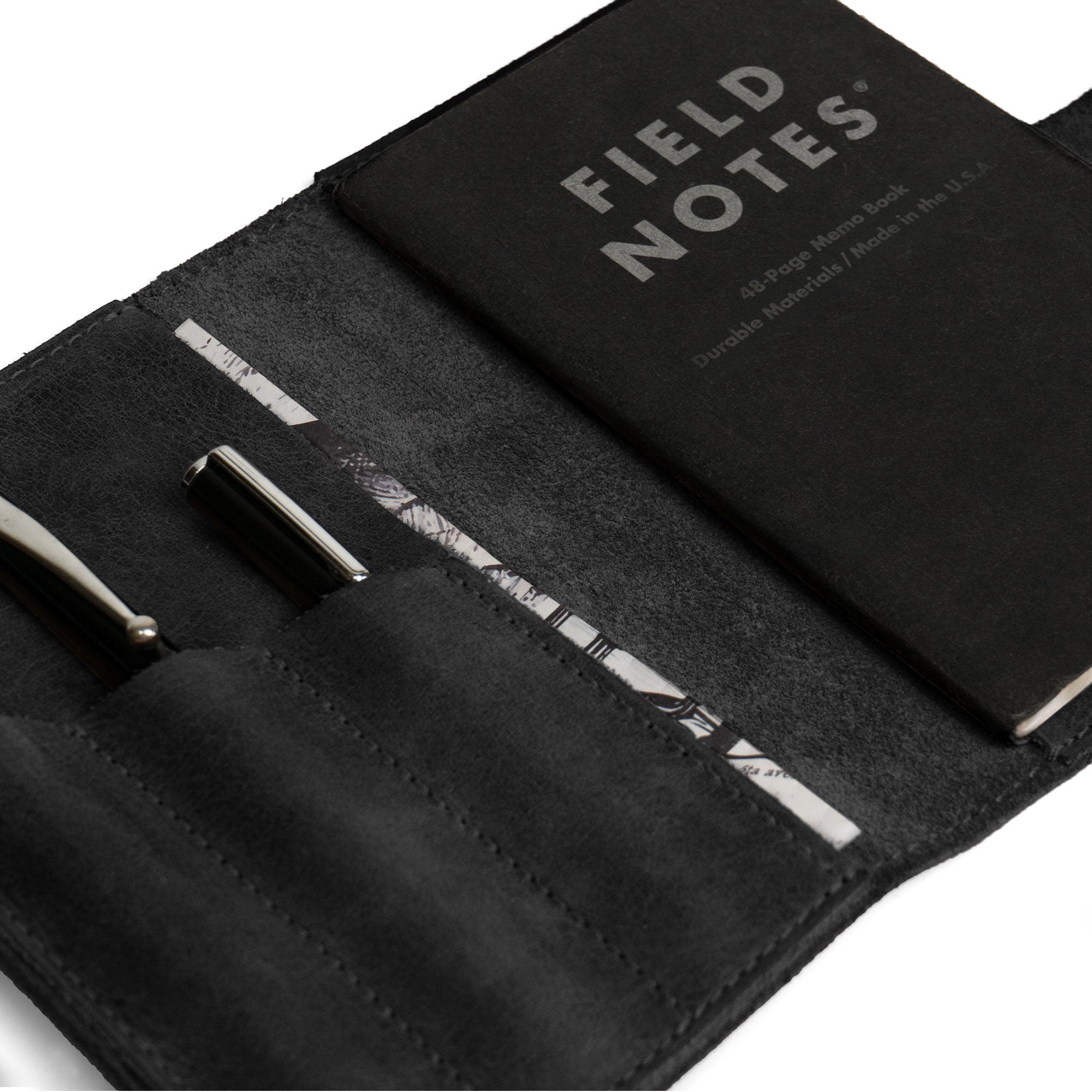Close-up of Leather Worx Field Notes Cover 3.5 x 5.5 in. Cover with Pen Slots in black, highlighting the craftsmanship. This stylish Full Grain Leather Cover for Field Notes (3.5 x 5.5 in.) is perfect as a notebook case or sleeve. Artisan-made in La Antigua Guatemala and Oaxaca Mexico, it showcases dedication to quality.