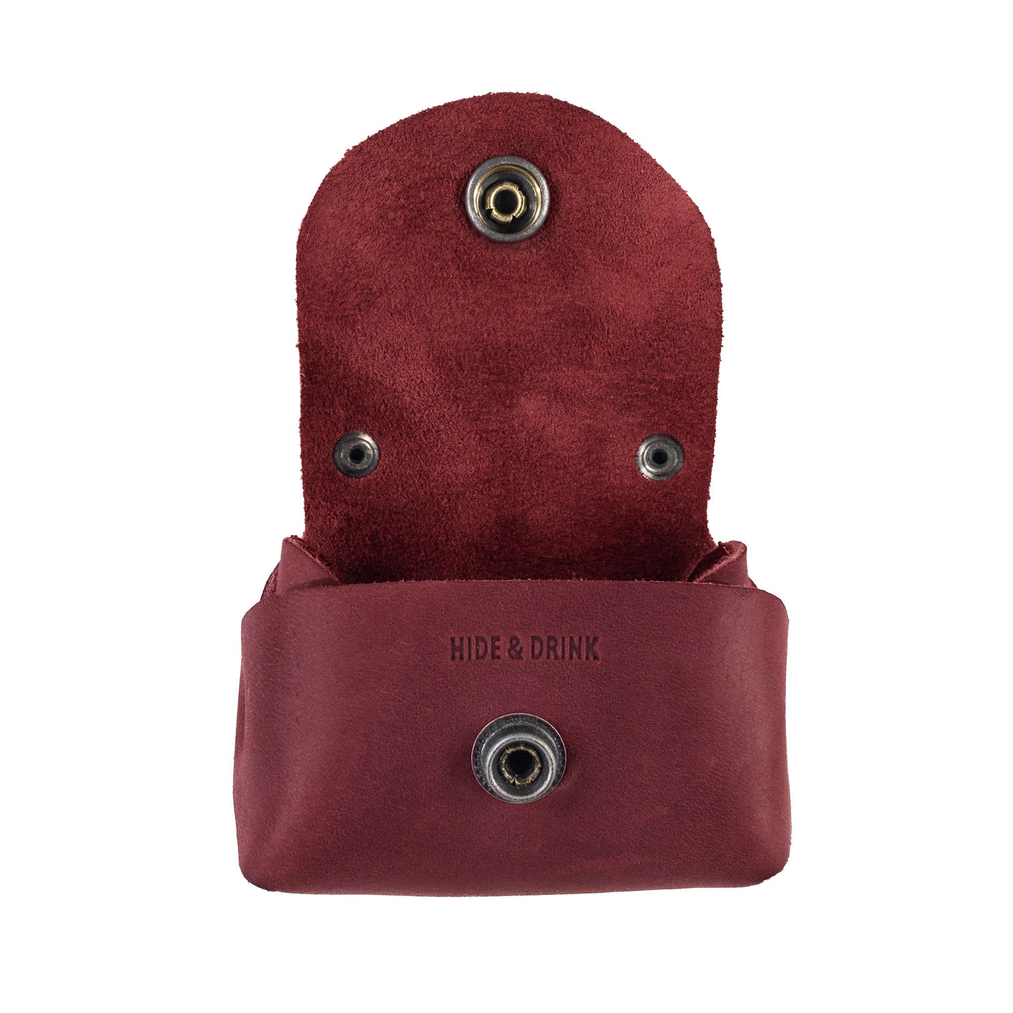 Open view of the Tiny Handbag Keychain by Hide & Drink, showcasing its soft suede lining and key ring. Crafted from Full Grain Leather, this item epitomizes artisan craftsmanship and small batch production, perfect for everyday use.