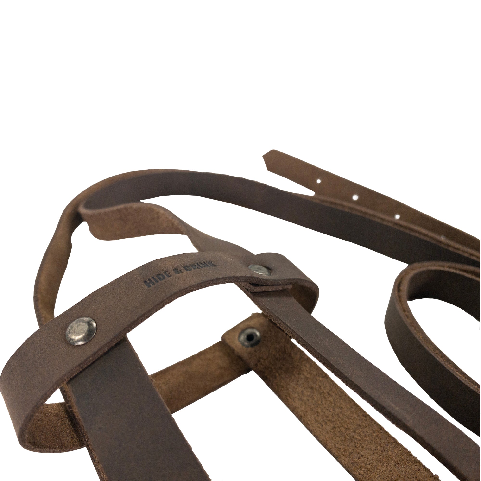 Close-up of the strap and leather used in Hide & Drink’s Riveted Bottle Carrier (Bottle Included), emphasizing the quality and detailing of the full grain leather. This travel accessory represents artisan craftsmanship and features small batch production, hand cut, hand sewn, and fire branded in La Antigua Guatemala & Oaxaca Mexico.