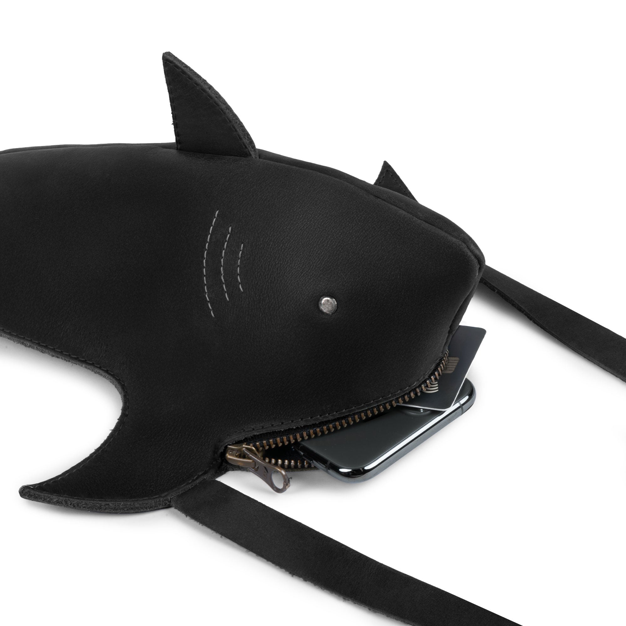 Close-up of the Shark-Shaped Shoulder Bag by Tudi Frudi, revealing the spacious interior designed to hold essentials. Made from Full Grain Leather, this handmade bag emphasizes small batch production and artisan skills in La Antigua Guatemala and Oaxaca Mexico.