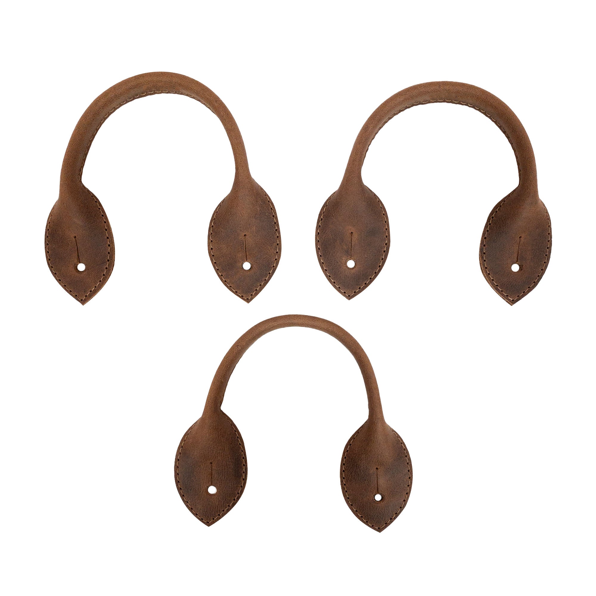 Close-up view of the Set of 3 Button End Attachments for Suspenders by Hide & Groom, highlighting the unique shape and full grain leather texture. Great for groomsmen and wedding ceremonies, these hand cut and hand sewn attachments reflect artisan craftsmanship from La Antigua Guatemala.