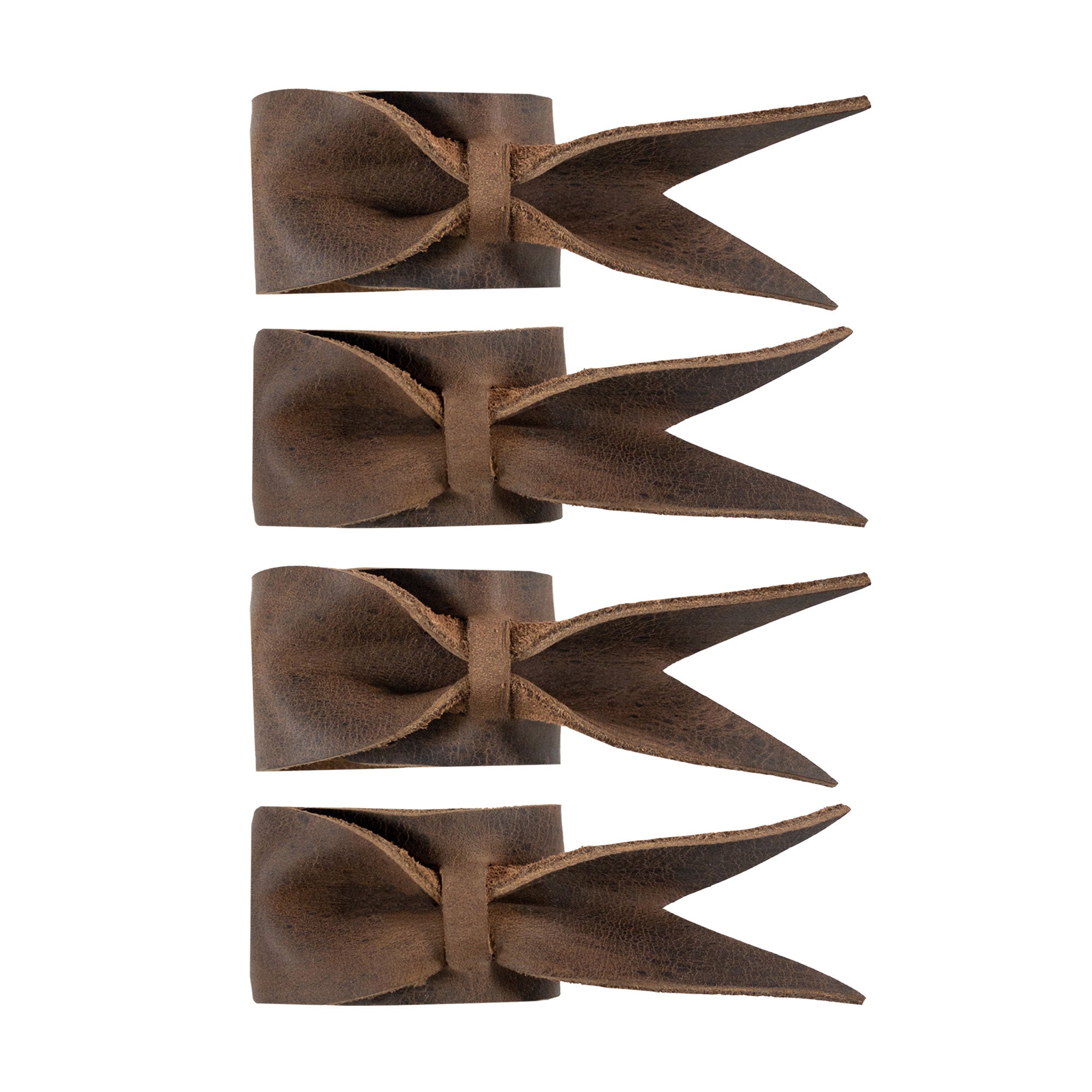 Chic Set of 4 Napkin Rings for Weddings by Hide & Groom, displaying a close-up of leather napkin rings with a unique bow design. These napkin holders are perfect for wedding receptions and dinner parties, utilizing full grain leather through hand cut and hand sewn methods, crafted in La Antigua Guatemala & Oaxaca Mexico.