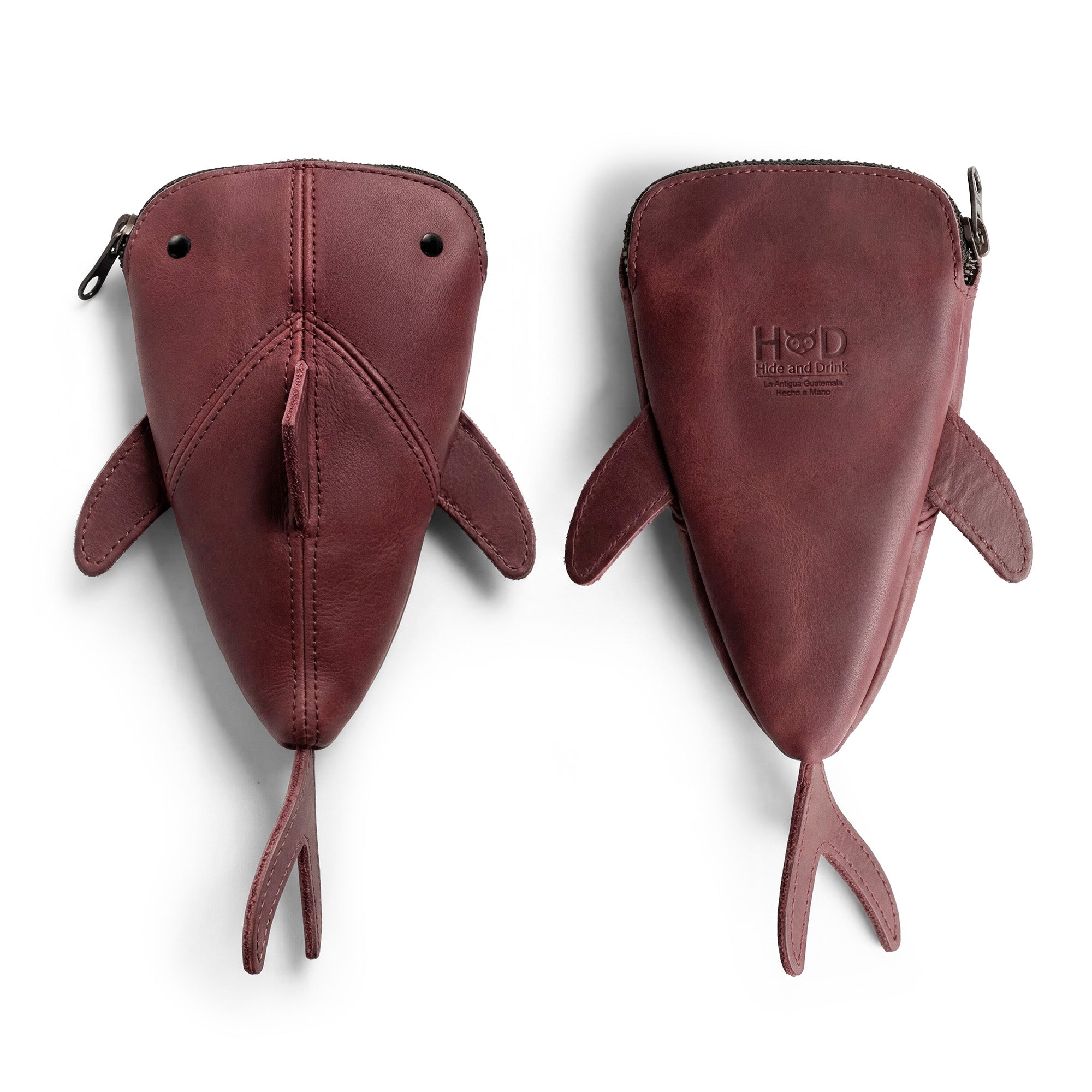 Top view of the Hide & Drink Leather Shark Pouch, emphasizing its unique shape and design. Ideal for use as a wallet, stuffed animal, or shark-shaped cable holder, this full grain leather pouch is perfect for organizing accessories. Each piece is artisan-made, reflecting the dedication of small batch production from La Antigua Guatemala & Oaxaca Mexico.