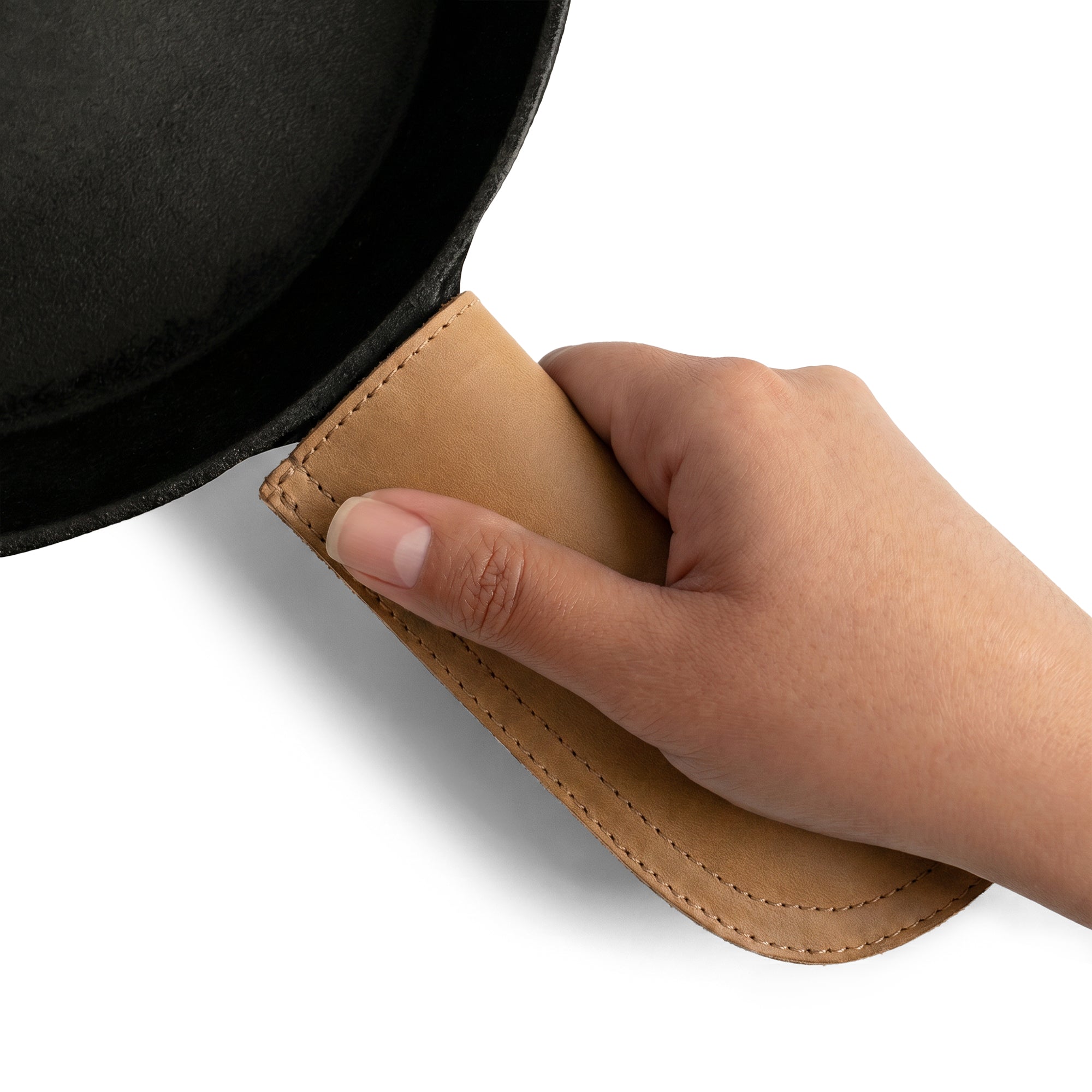Hide & Drink Cast Iron Panhandle Cover shown on a skillet, highlighting quality craftsmanship. This artisan hot handle protector combines design and functionality, made from full grain leather with double stitched durability. Handmade in La Antigua Guatemala & Oaxaca Mexico, it's a stylish choice for kitchen safety.