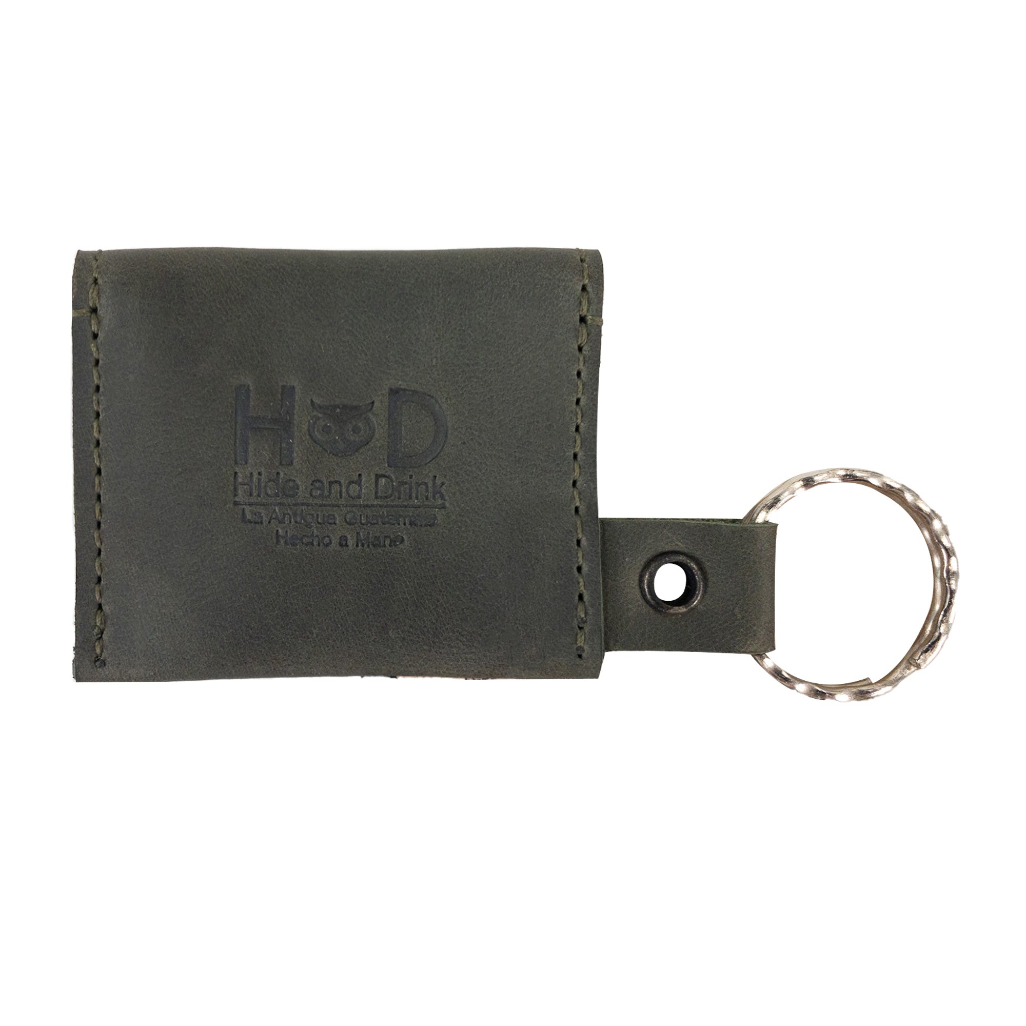 A practical view of the Tiny Coin Holder Keychain by Hide & Drink for coins, showing its functionality. This Tiny Coin Holder, crafted in Full Grain Leather, embodies small batch production and expert artisan skill.