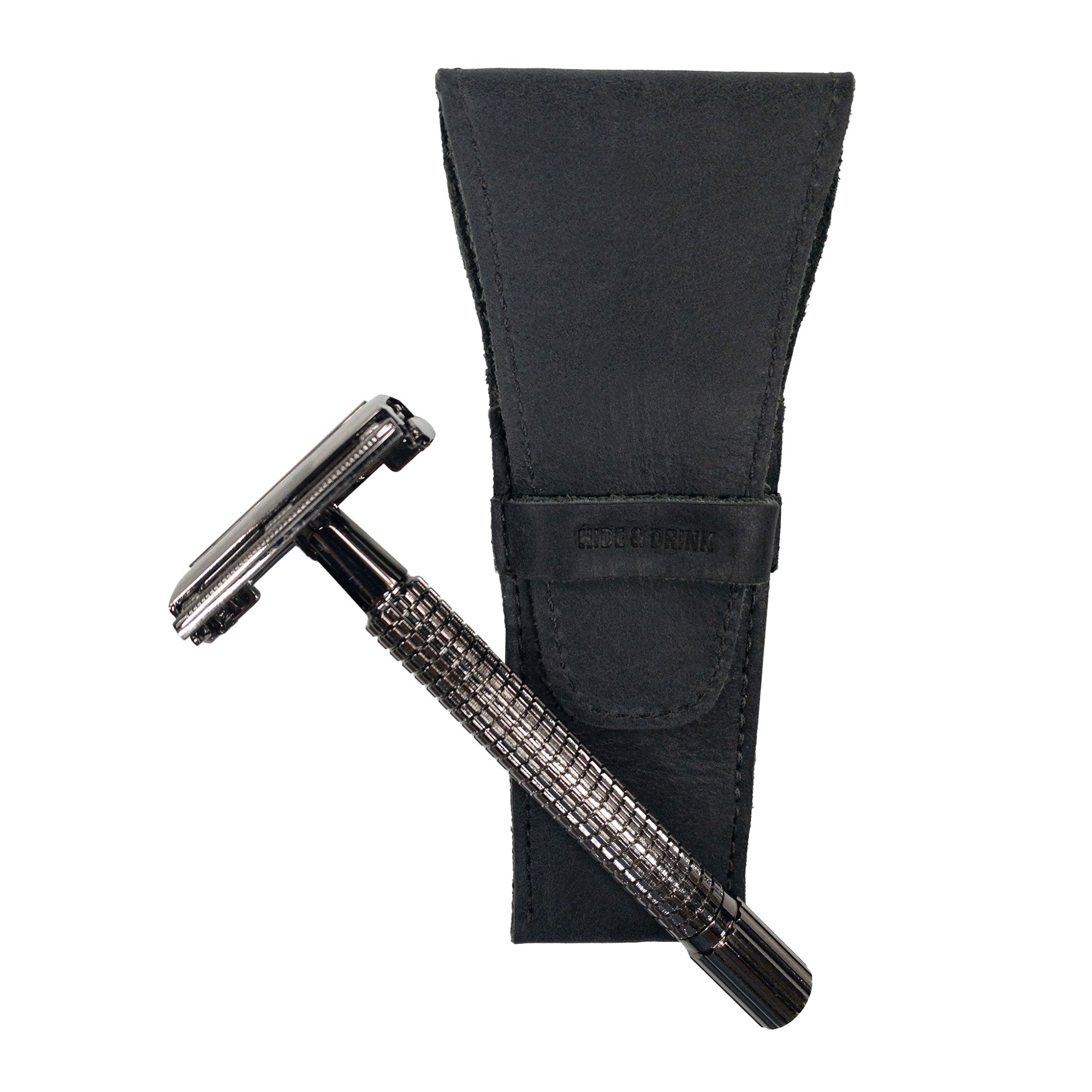 The black Safety Razor Case by Hide & Drink alongside a razor, showcasing its sleek design and quality. Perfect for personal care and shaving accessories, this artisan product is made from full grain leather and crafted in La Antigua Guatemala and Oaxaca Mexico.