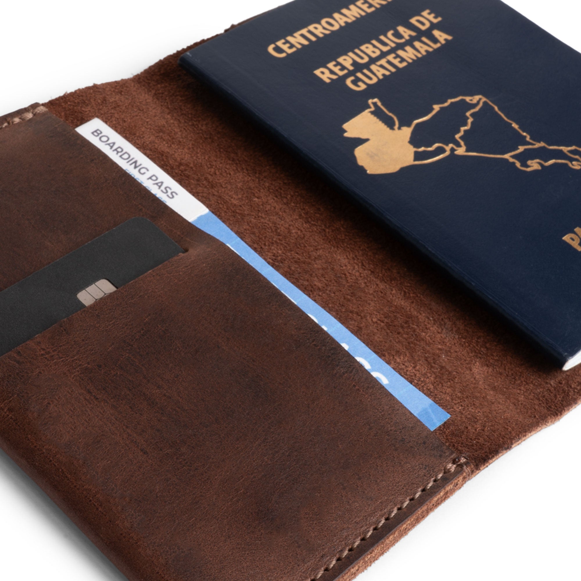 Detailed close-up of Hide & Drink's Passport Case With Card Holder, revealing a credit card slot paired with a passport. This essential travel accessory combines functionality and style, featuring full grain leather that ages beautifully, crafted by artisans in La Antigua Guatemala & Oaxaca Mexico.