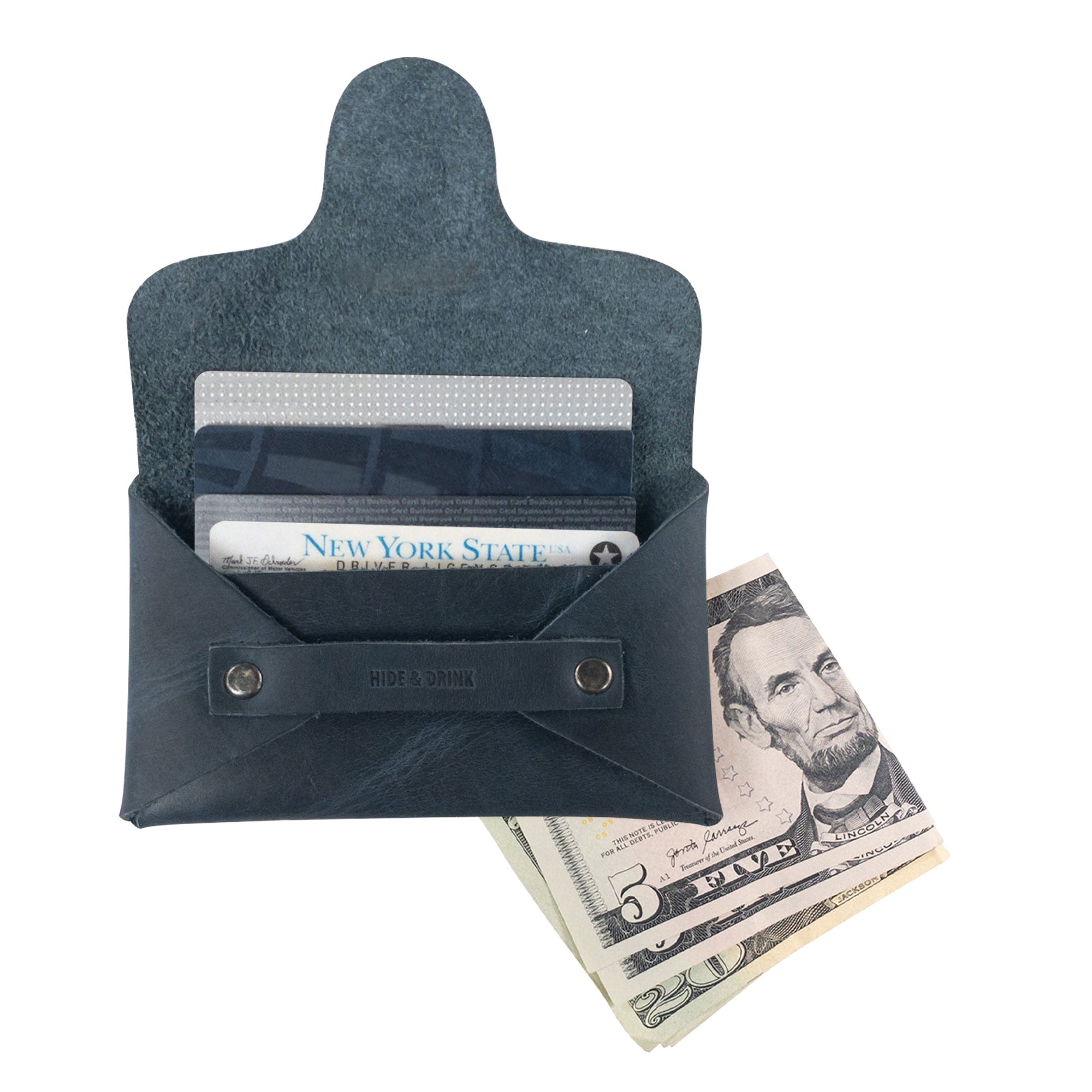 A Snapless Business Card Holder by Hide & Drink, filled with essential cards and cash, showcasing its unique functionality. This vintage wallet for men and women is made from rich Full Grain Leather, functioning as a sturdy pouch and money organizer, highlighting artisan production from La Antigua Guatemala and Oaxaca Mexico.