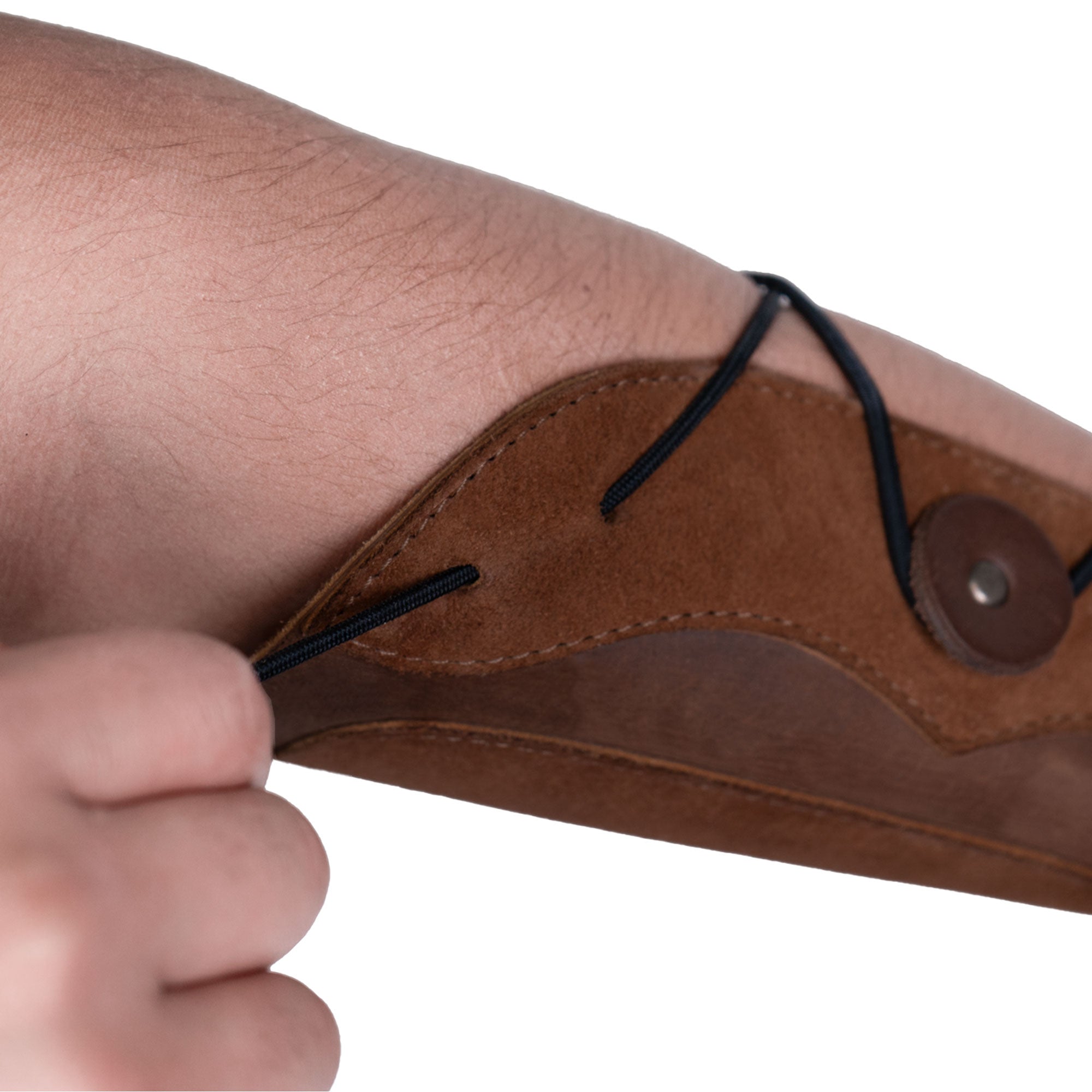 Detail image focusing on the adjustable strap and unique design of the Elastic Archery Bracer by Valhalla Gear, made for comfort and protection while practicing archery. This wrist guard is handcrafted from full grain leather, showcasing a perfect fit for both casual users and cosplay enthusiasts.