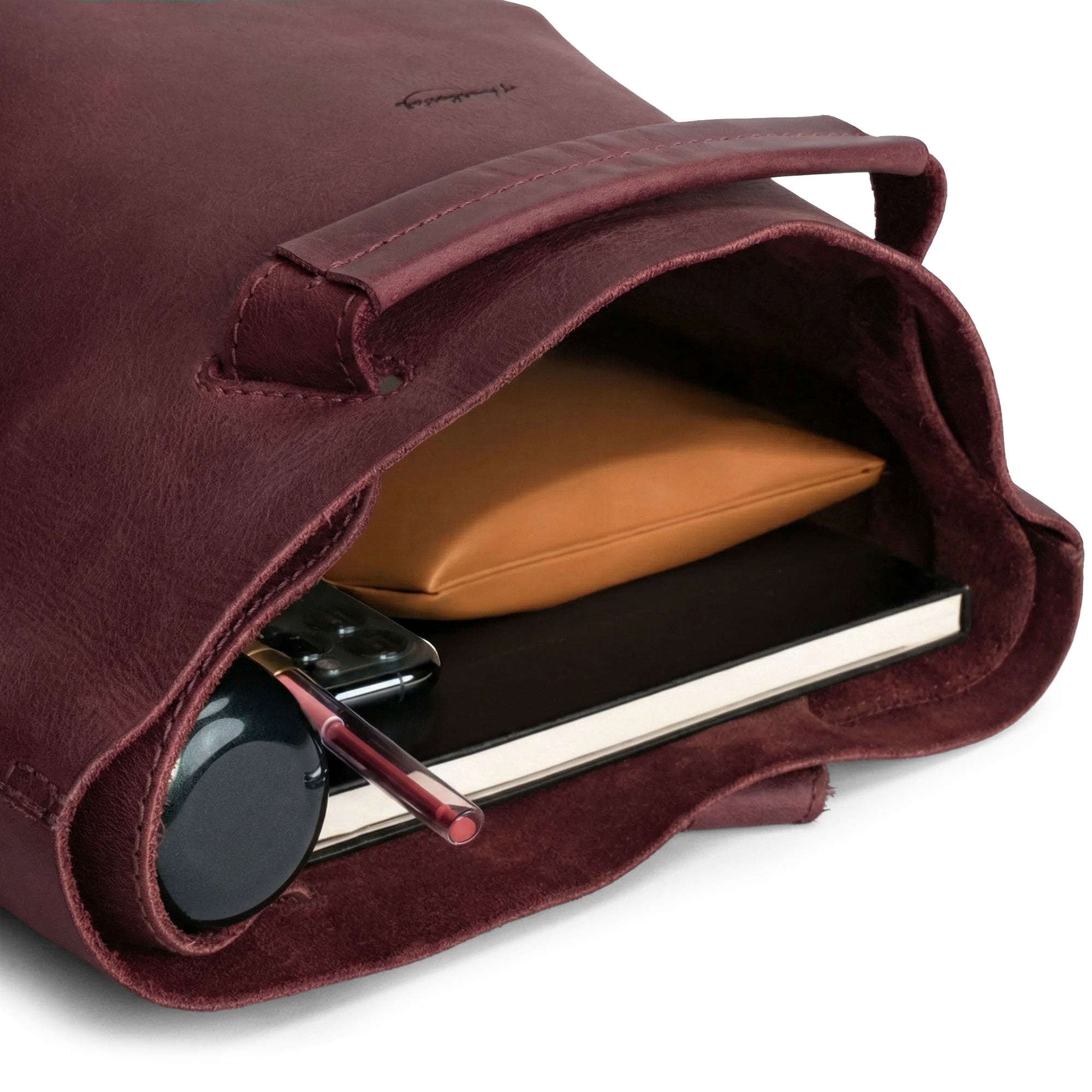 Inside view of Heather's Convertible Backpack to Shoulder Bag, revealing ample space for essentials. This spacious crossbody for women is created using Full Grain Leather with a design that underscores the value of small batch production, featuring hand cut and fire branded touches. Handmade in La Antigua Guatemala & Oaxaca Mexico.