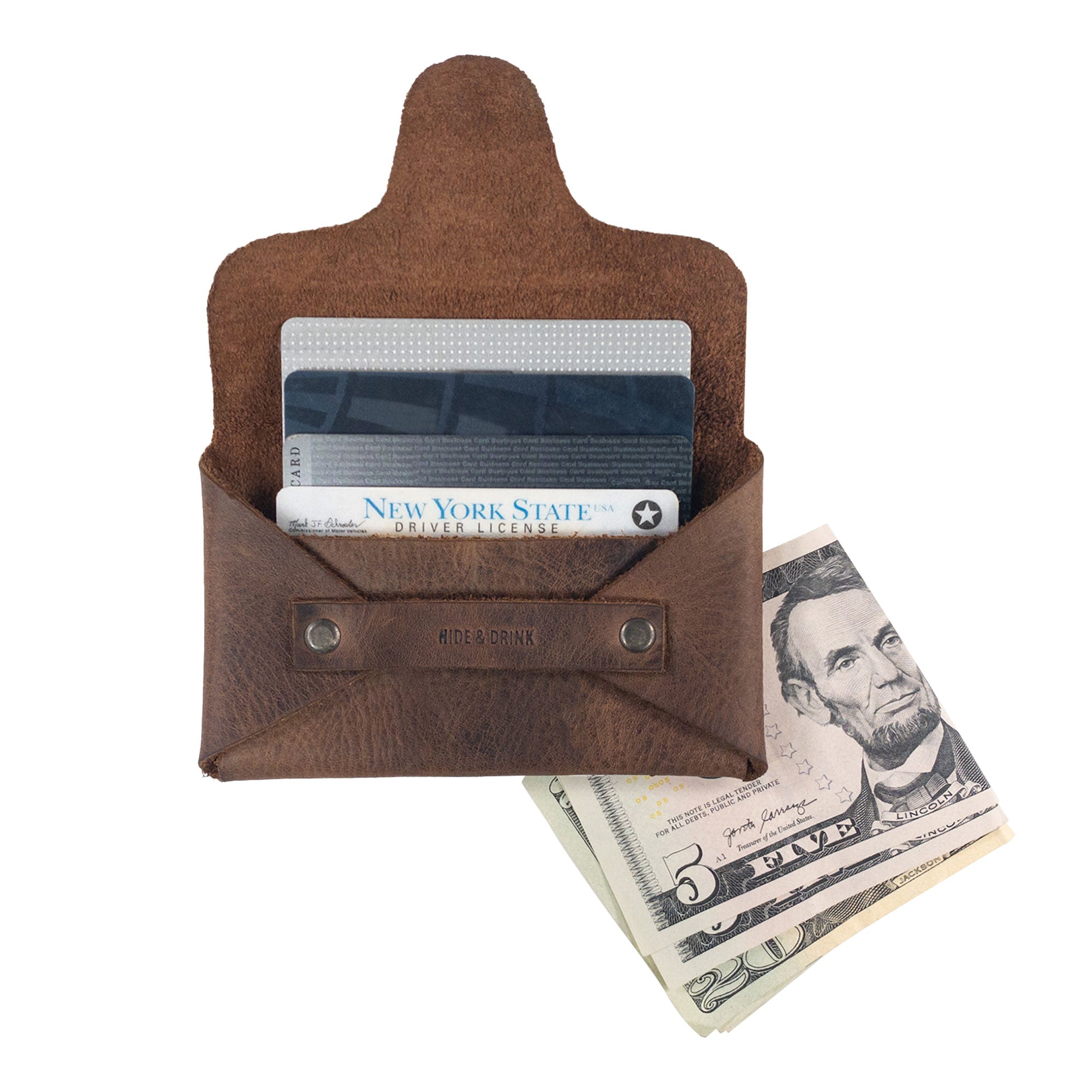 Hide & Drink's Snapless Business Card Holder opened to display cards and cash, demonstrating its functionality as a vintage wallet. Designed as a sturdy pouch and money organizer, it is made from high-quality Full Grain Leather. This piece is part of small batch production, ensuring meticulous hand cut and hand sewn craftsmanship in La Antigua Guatemala and Oaxaca Mexico.