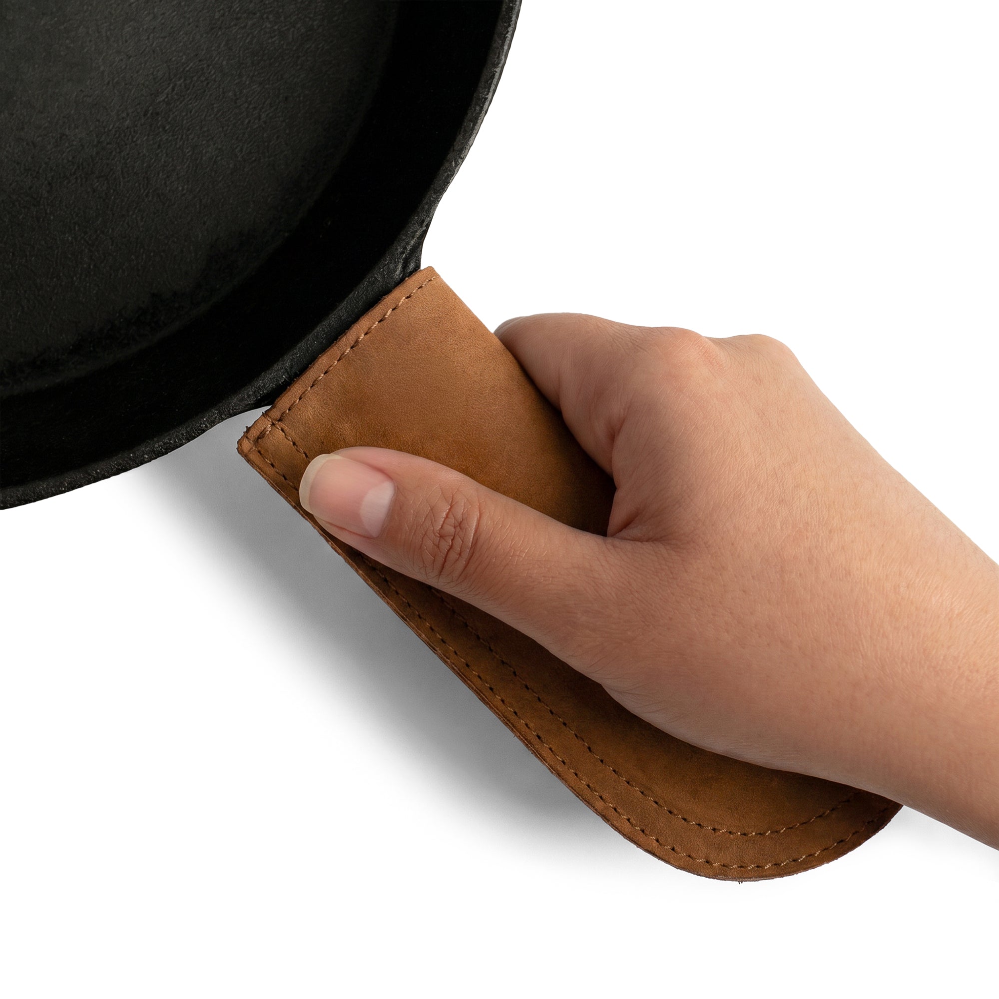 Hide & Drink Cast Iron Panhandle Cover featured prominently on a metal skillet. A perfect hot handle protector, this double layered piece nicely showcases the full grain leather craftsmanship. Handmade in La Antigua Guatemala & Oaxaca Mexico, it combines functionality with style, ideal for any culinary enthusiast.