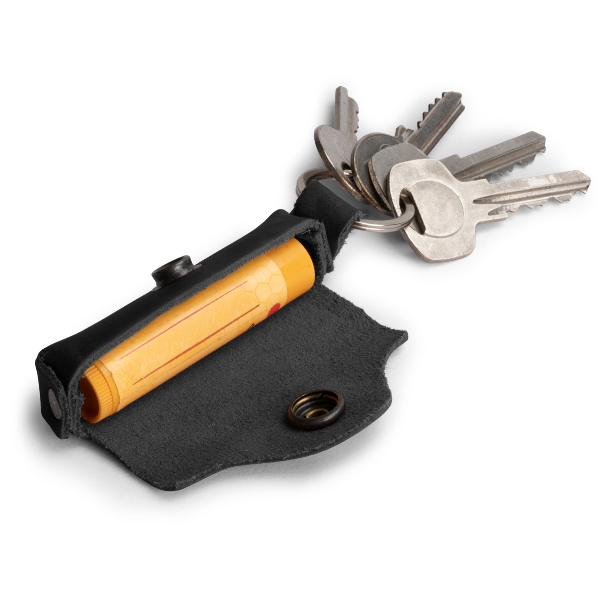 Artisan Lip Balm Key Chain by Hide & Drink showcasing a stylish and functional design. Crafted from full grain leather with a secure brass metal clasp, handmade in La Antigua Guatemala.