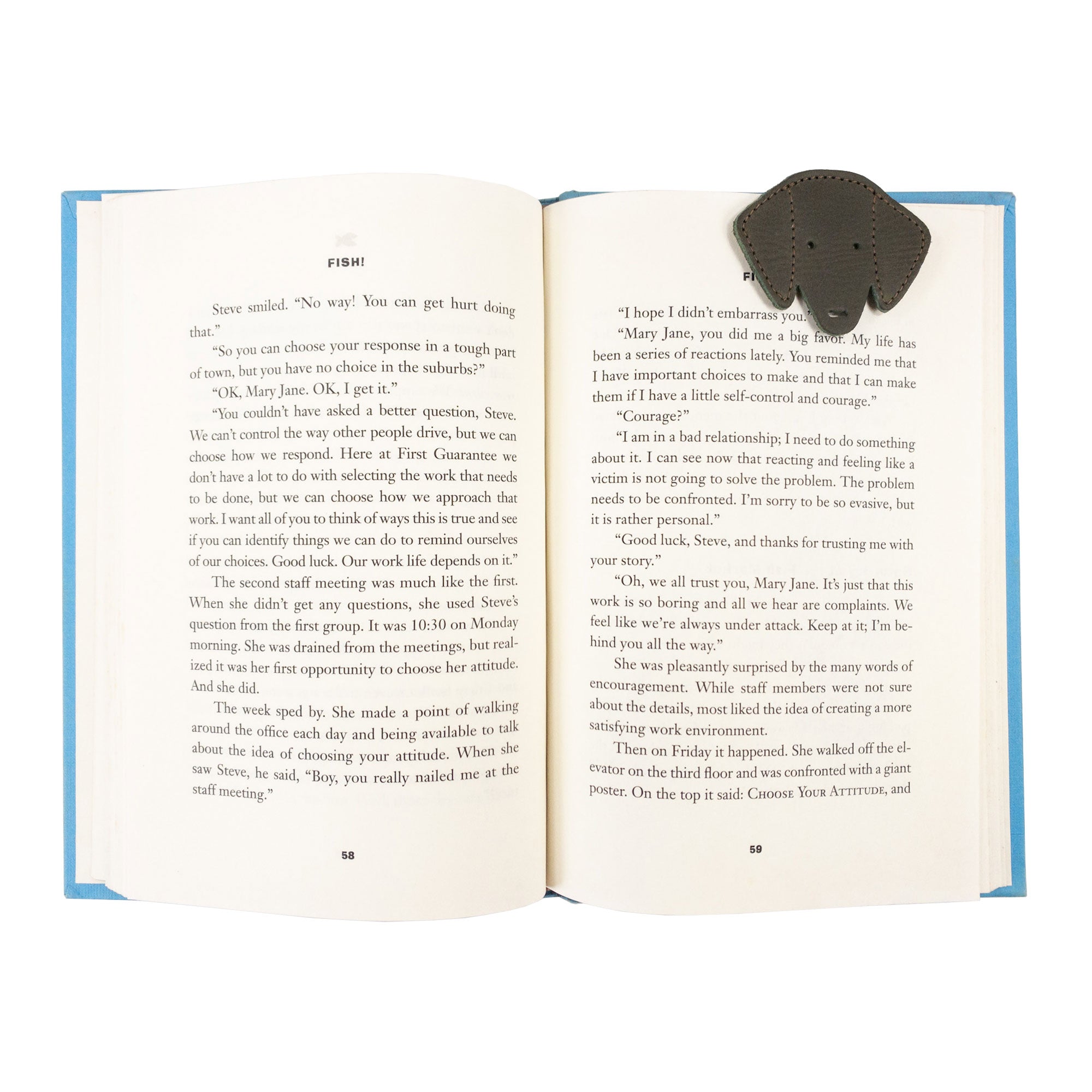 Hide & Drink's brown Dog Bookmark nestled in a book page, made from Full Grain Leather. This artisanal bookmark showcases small batch production, fire branding, and craftsmanship from La Antigua Guatemala & Oaxaca Mexico.