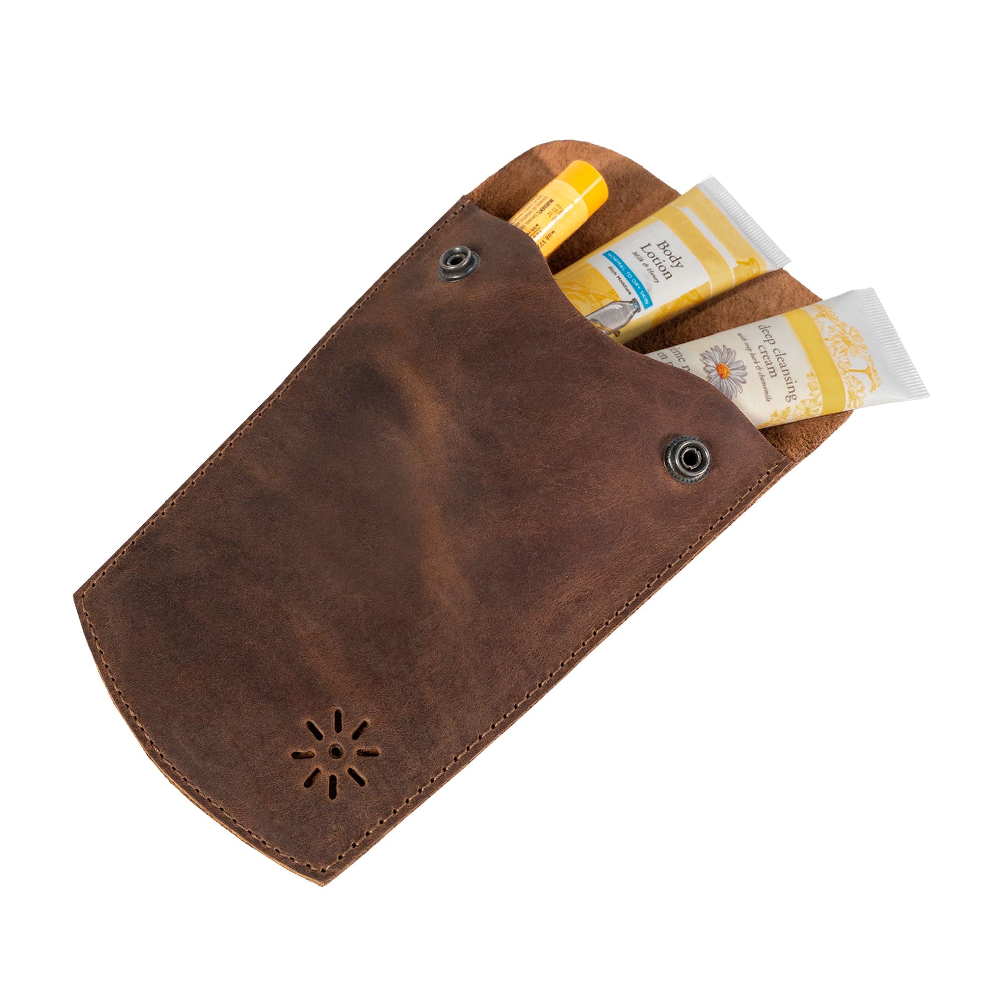 Heather's Essential Mini Bag filled with lip balm and sunscreen, ideal for on-the-go convenience. This mini bag for women serves as an essential case for glasses, makeup, USB, cables and cash, perfect as a travel accessory. Handcrafted from full grain leather in La Antigua Guatemala, it emphasizes small batch production with hand cut and sewn details by talented artisans.