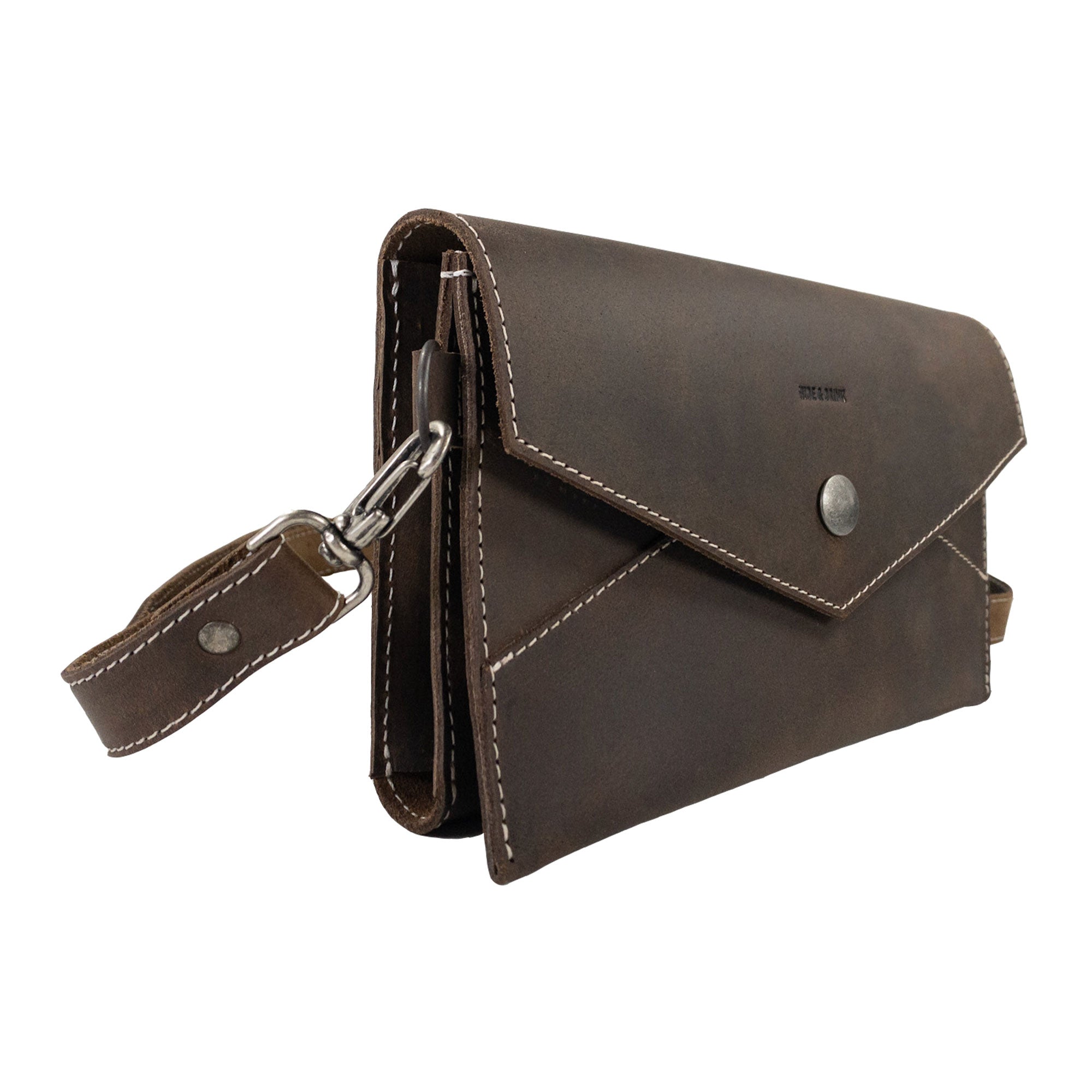 Side angle of the Convertible Envelope Bag by Hide & Drink, showcasing its elegant design and quality Full Grain Leather. Perfect as an Envelope Crossbody Bag, this piece is handmade, representing small batch production by talented artisans in La Antigua Guatemala & Oaxaca Mexico.
