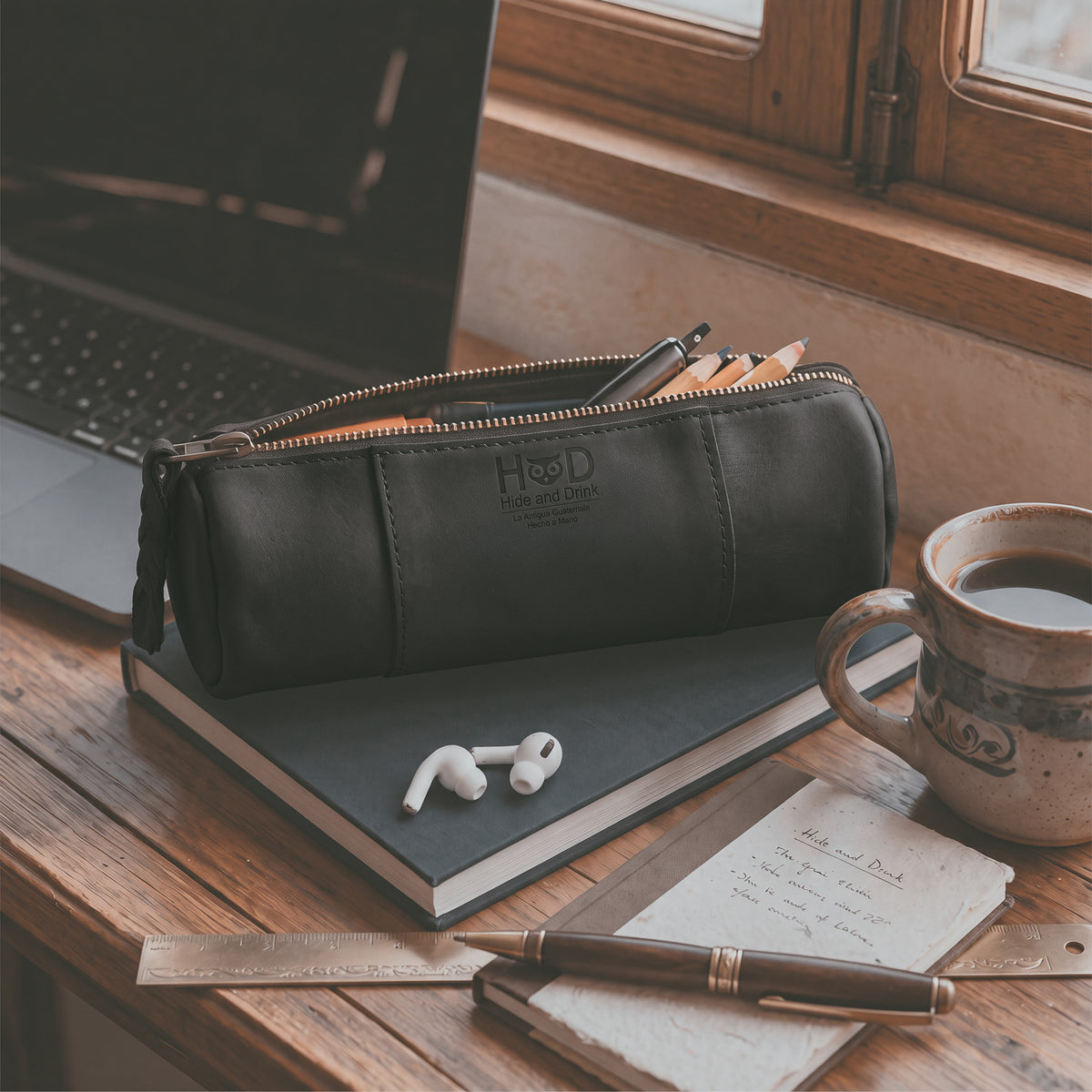 Inside view of the Utility Cylinder Case by Hide & Drink, featuring a spacious interior ideal for organizing cables and personal items. This artisan bag, crafted from Full Grain Leather, embodies rustic style. Cylinder Case, Classic Bag, Handmade.