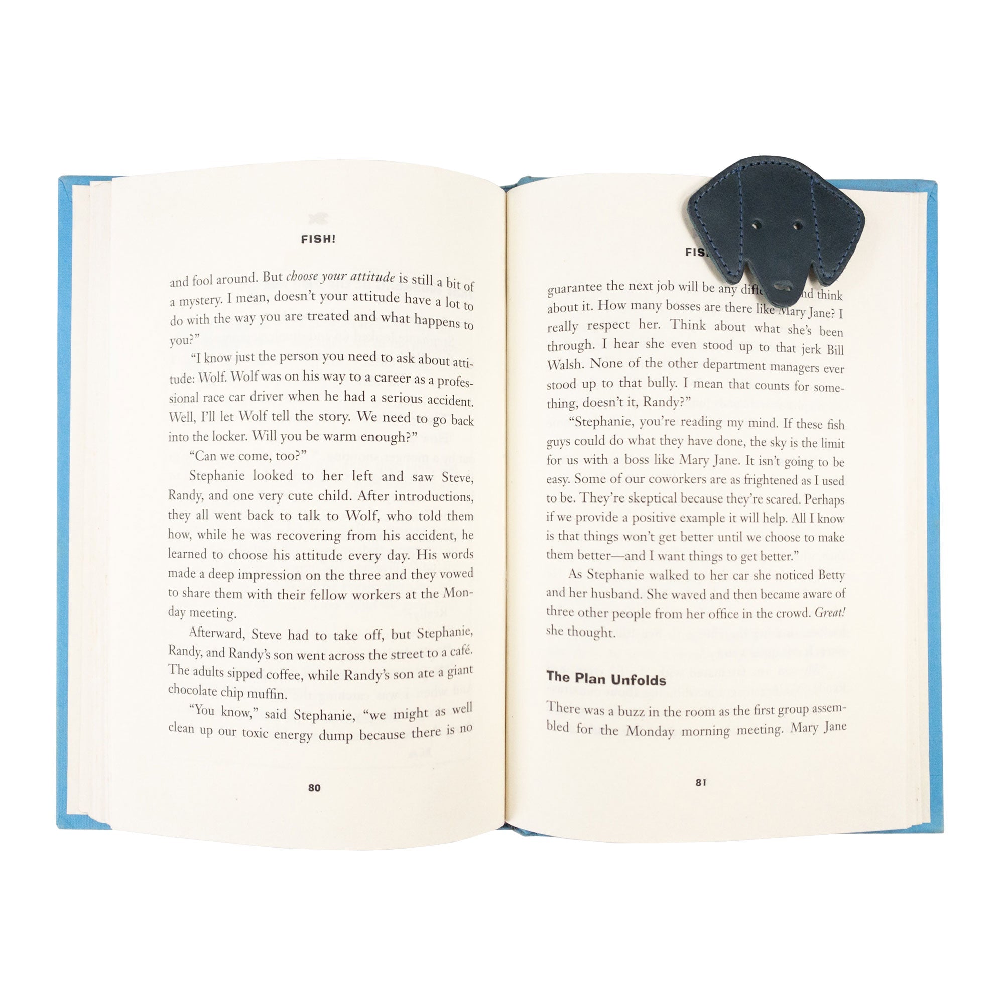 Hide & Drink's navy Dog Bookmark in use, enhancing the reading experience with its Full Grain Leather quality. This artisan bookmark highlights the craftsmanship of small batch production and fire branding from La Antigua Guatemala & Oaxaca Mexico.