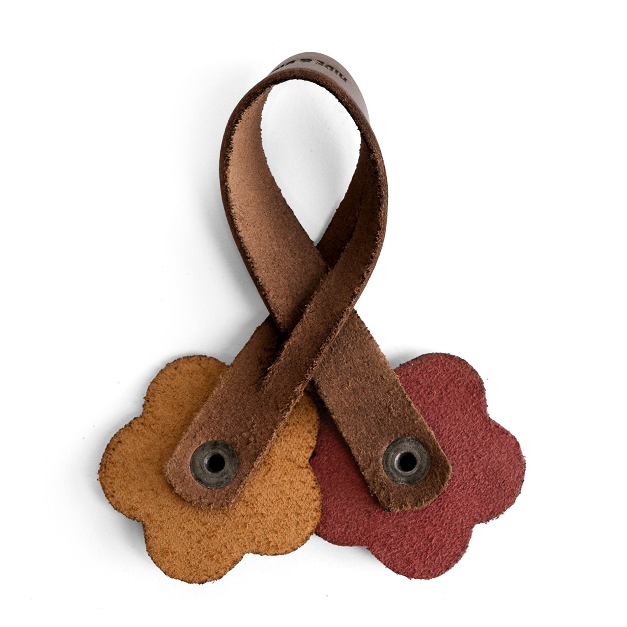 Detailed view of the Rose Bag Ornament by Hide & Drink, handmade from Full Grain Leather, featuring flower-shaped designs. A charming accessory for totes and bags, perfect for adding a stylish touch.