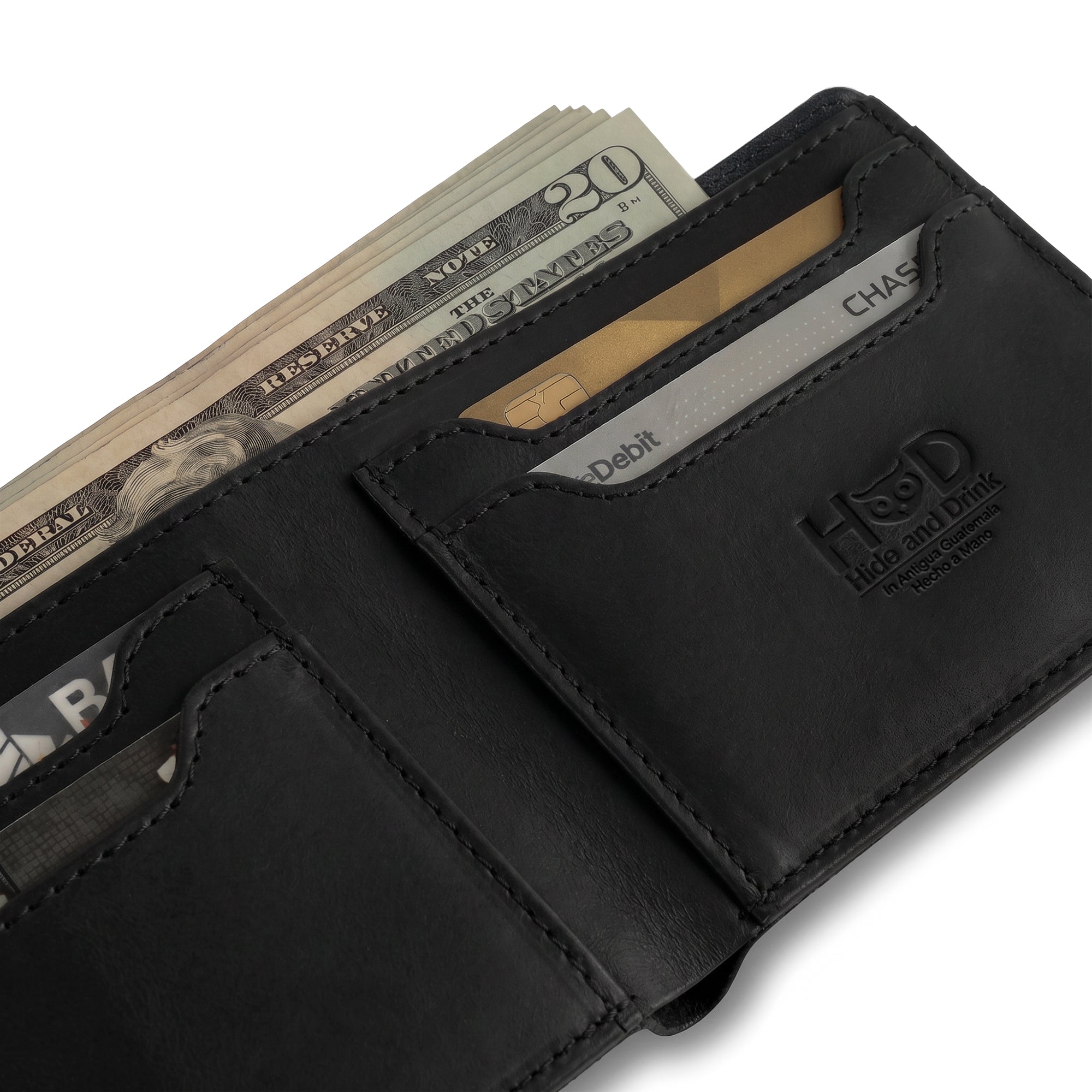 Dimensions of the dark brown Classic Wallet by Hide & Drink laid out next to a measurement ruler. This Classic Bifold Wallet is crafted from Full Grain Leather, ensuring a functional storage case for identification. An essential travel accessory, it reflects artisan small batch production practices, hand cut and sewn in La Antigua Guatemala & Oaxaca Mexico.