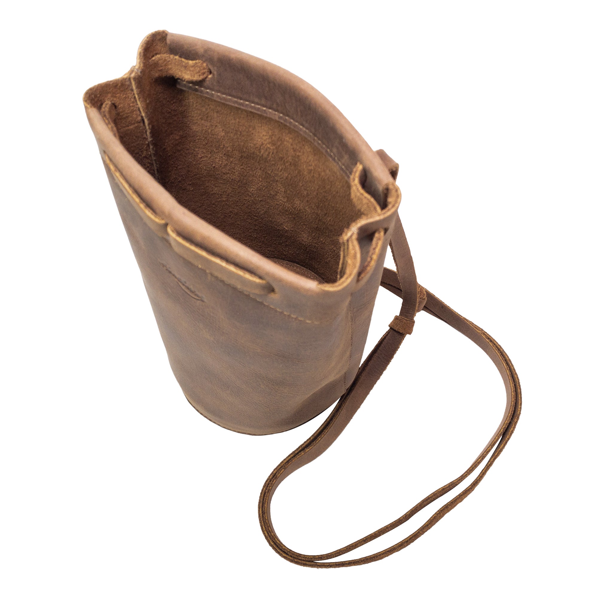 Top view of Heather's Cylinder Shoulder Phone Bag, showcasing the spacious opening. This stylish cylinder-shaped purse with an adjustable shoulder strap is crafted from full grain leather, underscoring the artisan effort from StockyardX and highlighting small batch production and hand cut, hand sewn craftsmanship. Handmade in La Antigua Guatemala & Oaxaca Mexico.