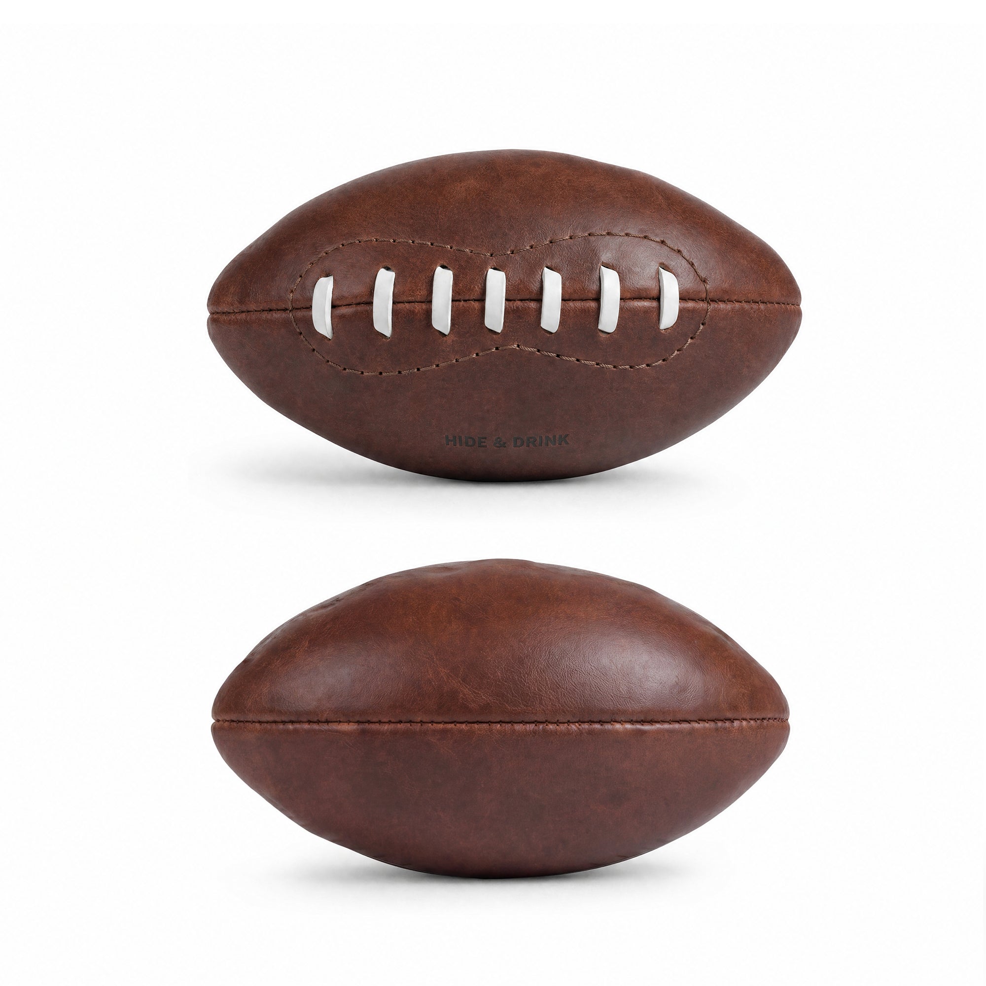 Side view of a Mini American Football by Hide & Drink, featuring authentic white laces and unique leather texture. Perfect as memorabilia or a decorative piece, this hand sewn ball is handmade in La Antigua Guatemala & Oaxaca Mexico, representing quality craftsmanship and artisan skills.