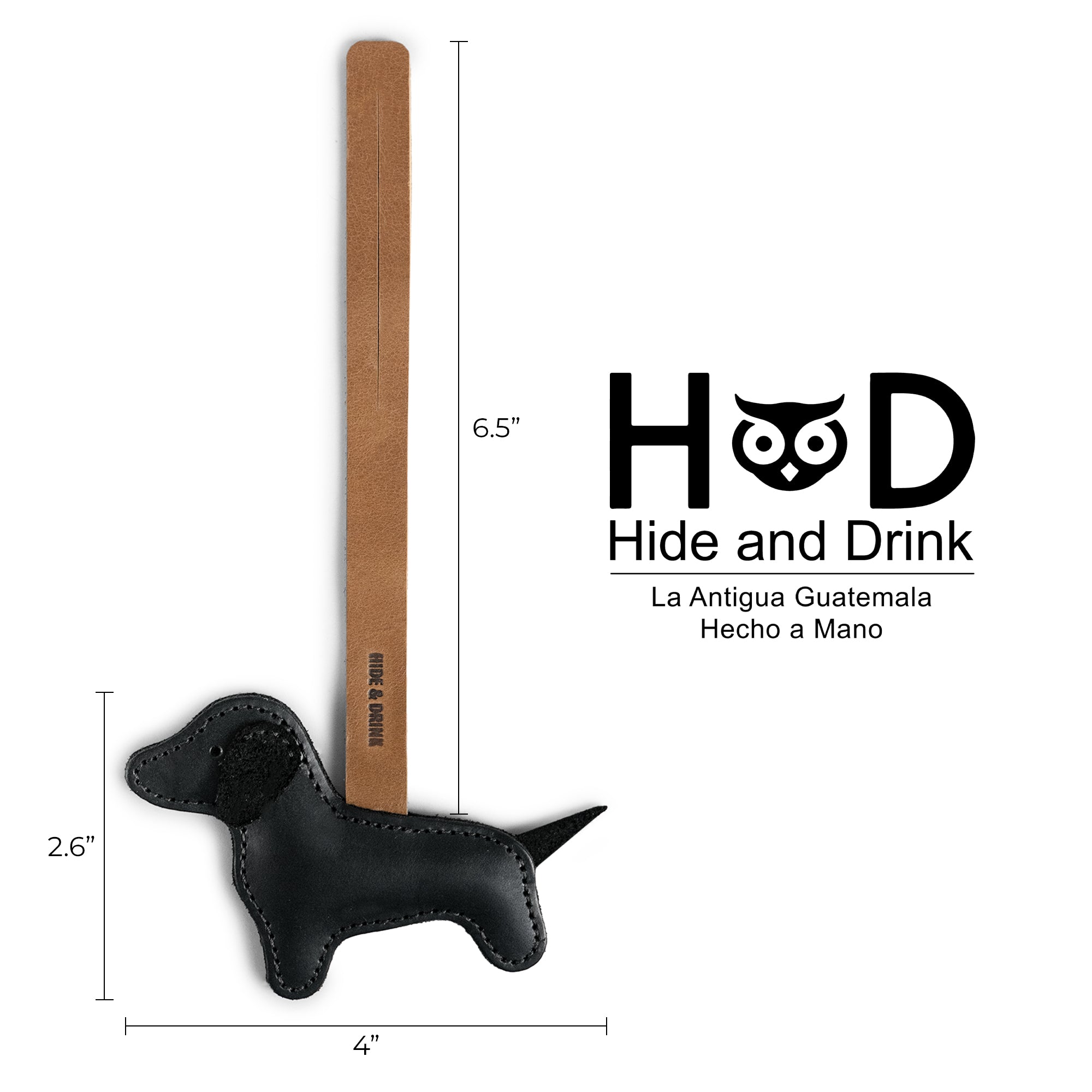 Product dimensions and branding details of the Hide & Drink Dachshund Bag Charm, featuring its stylish design. This Dachshund Bag Charm is not just a handbag ornament but a piece of handmade artistry, crafted from full grain leather in small batch production. Ideal for women seeking unique purse charms, it reflects the handcrafted elegance made in La Antigua, Guatemala and Oaxaca, Mexico.