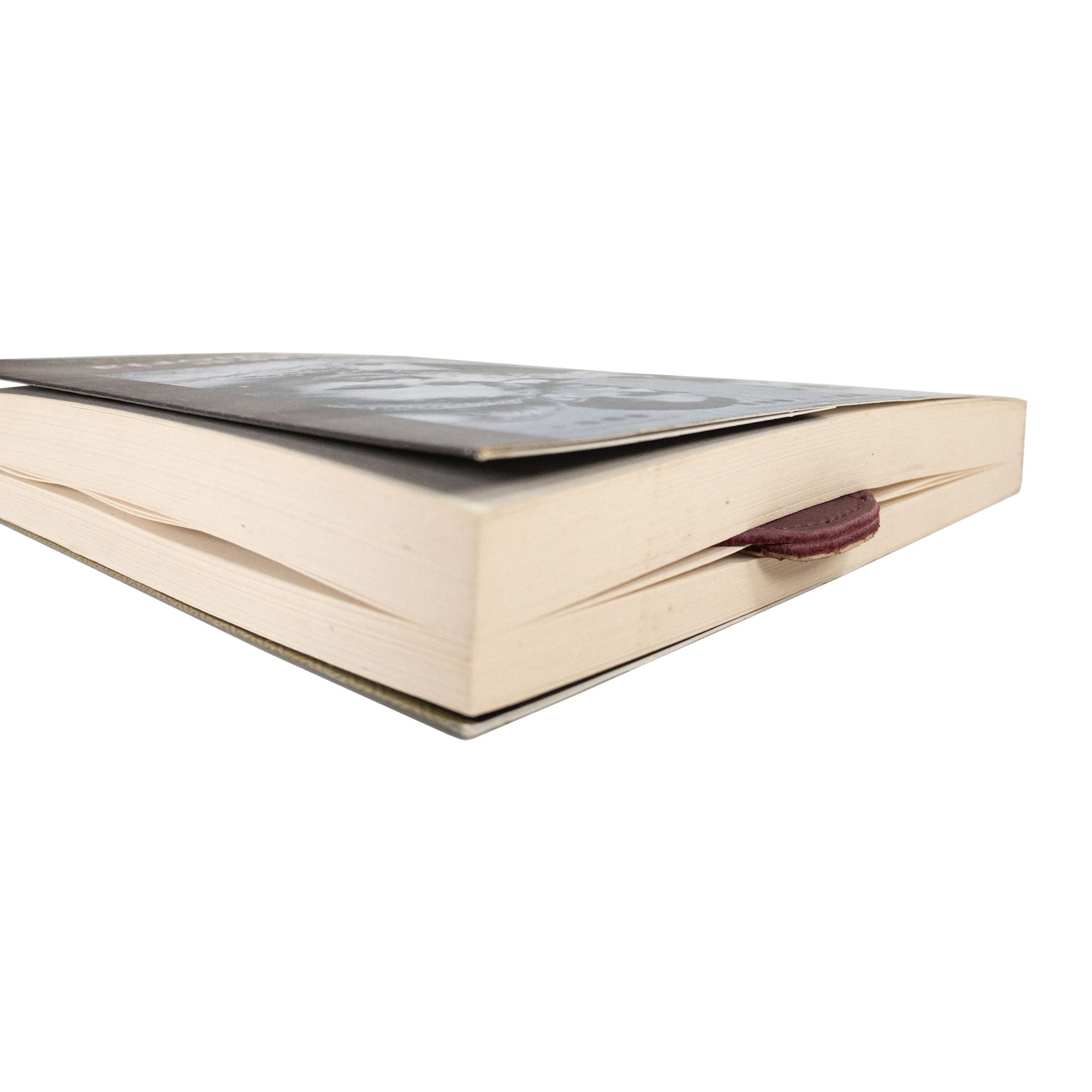 Side view of Hide & Drink's burgundy Dog Bookmark, featuring Full Grain Leather craftsmanship. This handmade bookmark showcases artisan details from small batch production and fire branding, made in La Antigua Guatemala & Oaxaca Mexico.