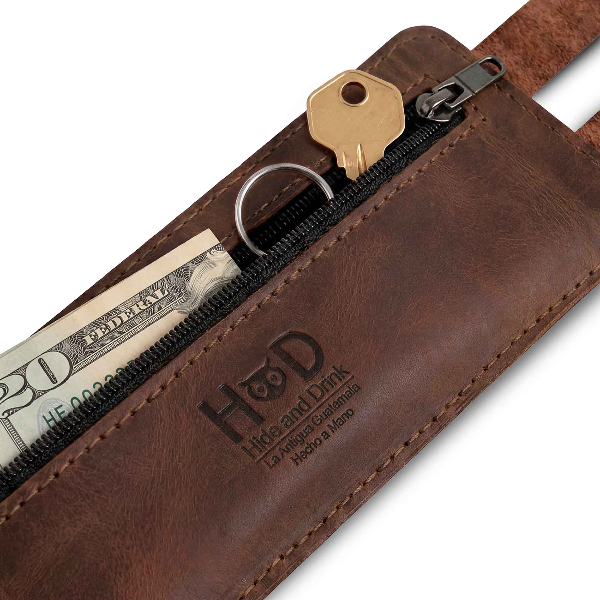 Hide & Drink's Wrist-Wallet-Cuff showcases a hidden pouch for bills, elegantly crafted from Full Grain Leather. This rustic leather bracelet design features an inner zippered pouch for easy organization. Each piece is uniquely handmade in La Antigua Guatemala & Oaxaca Mexico, highlighting skilled artisanal craftsmanship and fire-branded details.