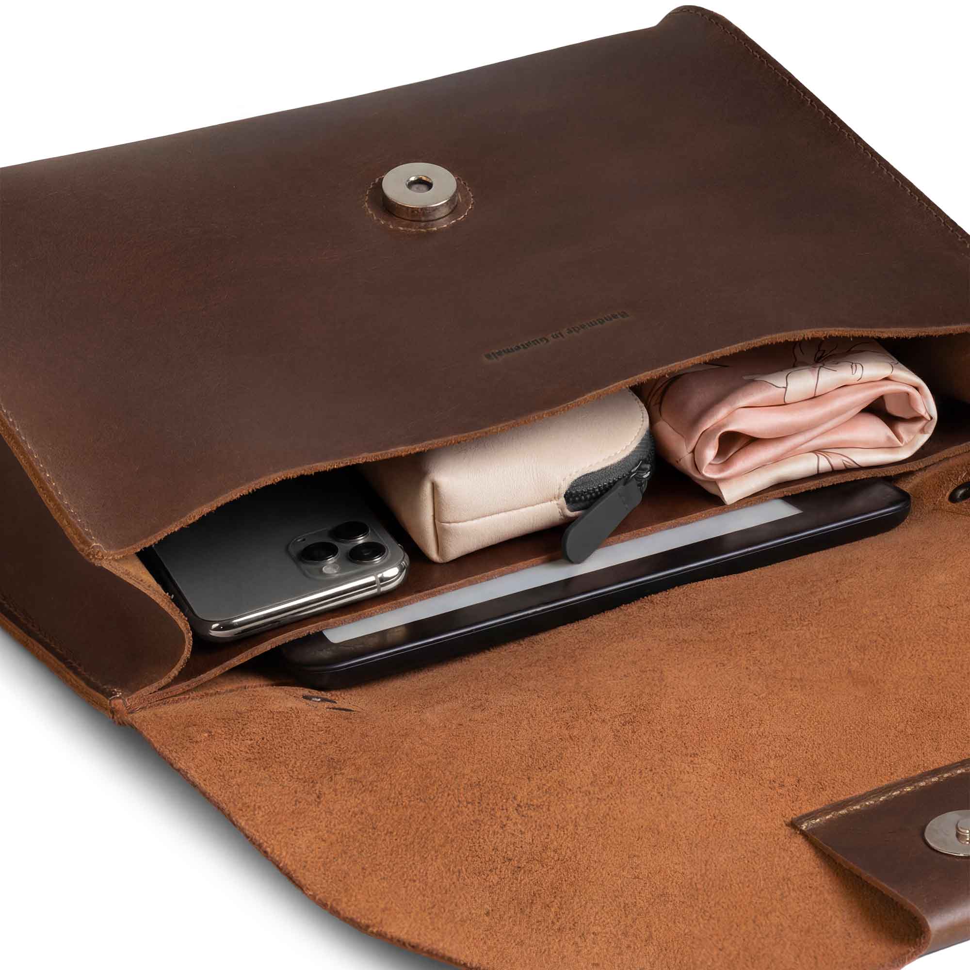 The Burnet Crossbody opened up to reveal its organized space, featuring full grain leather and highlighting Austin Genuine's commitment to artisan quality. Designed with small batch production, this purse is hand cut and hand sewn, made in La Antigua Guatemala & Oaxaca Mexico.