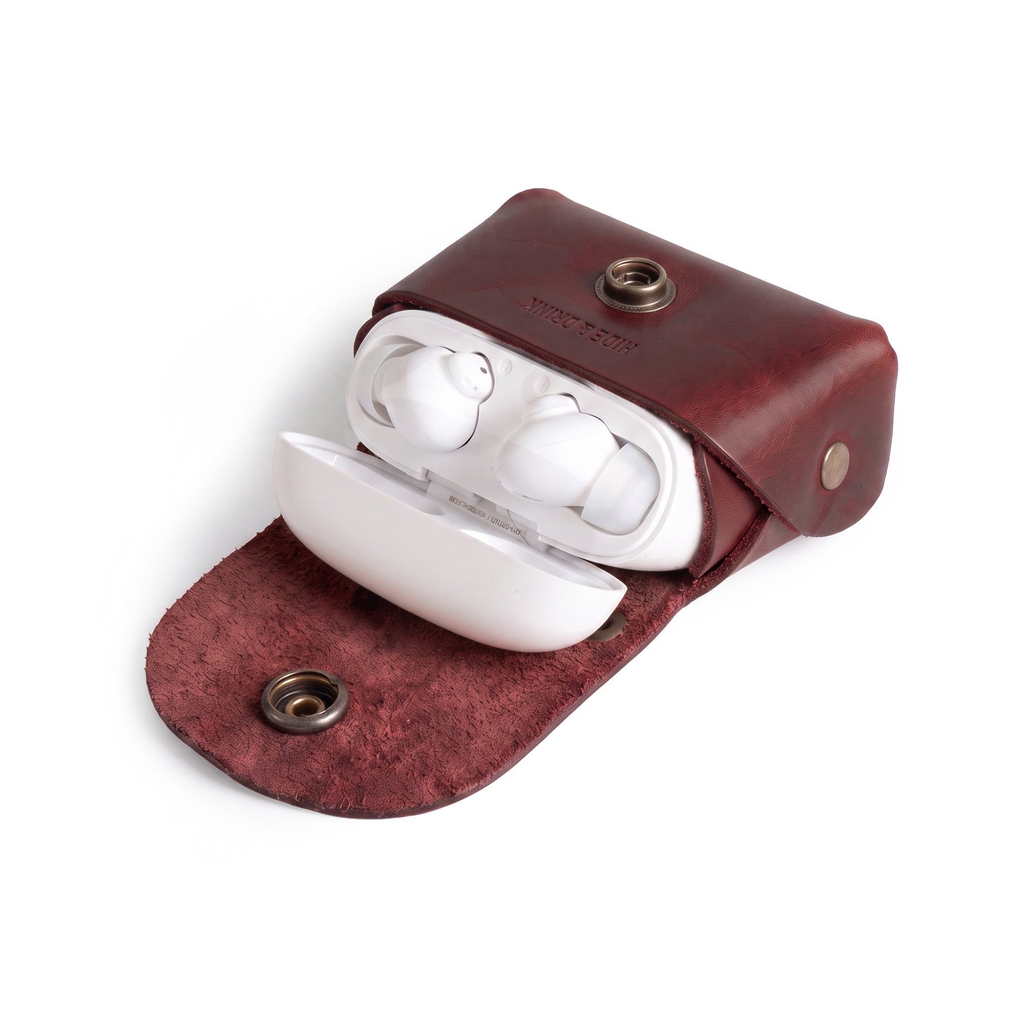 Inside view of the Tiny Handbag Keychain by Hide & Drink, filled with coins and keys, demonstrating the functional layout. This unique keychain in Full Grain Leather represents artisan quality through small batch production and meticulous hand cut and hand sewn techniques.