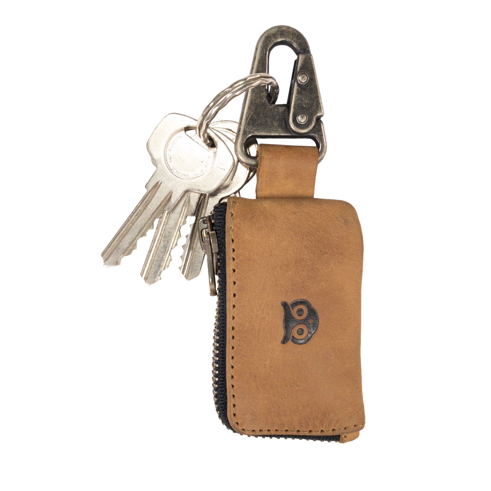 Car Key Holder by Hide & Drink, designed in an attractive brown color, showcasing its practicality for securing keys and cash while also providing space for Headphone and charging Cables, Memory Cards, and Flash Drives. This product is crafted from Full Grain Leather and features a reliable Nickel Metal Clasp, exemplifying artisan craftsmanship from Small Batch Production in La Antigua Guatemala & Oaxaca Mexico.