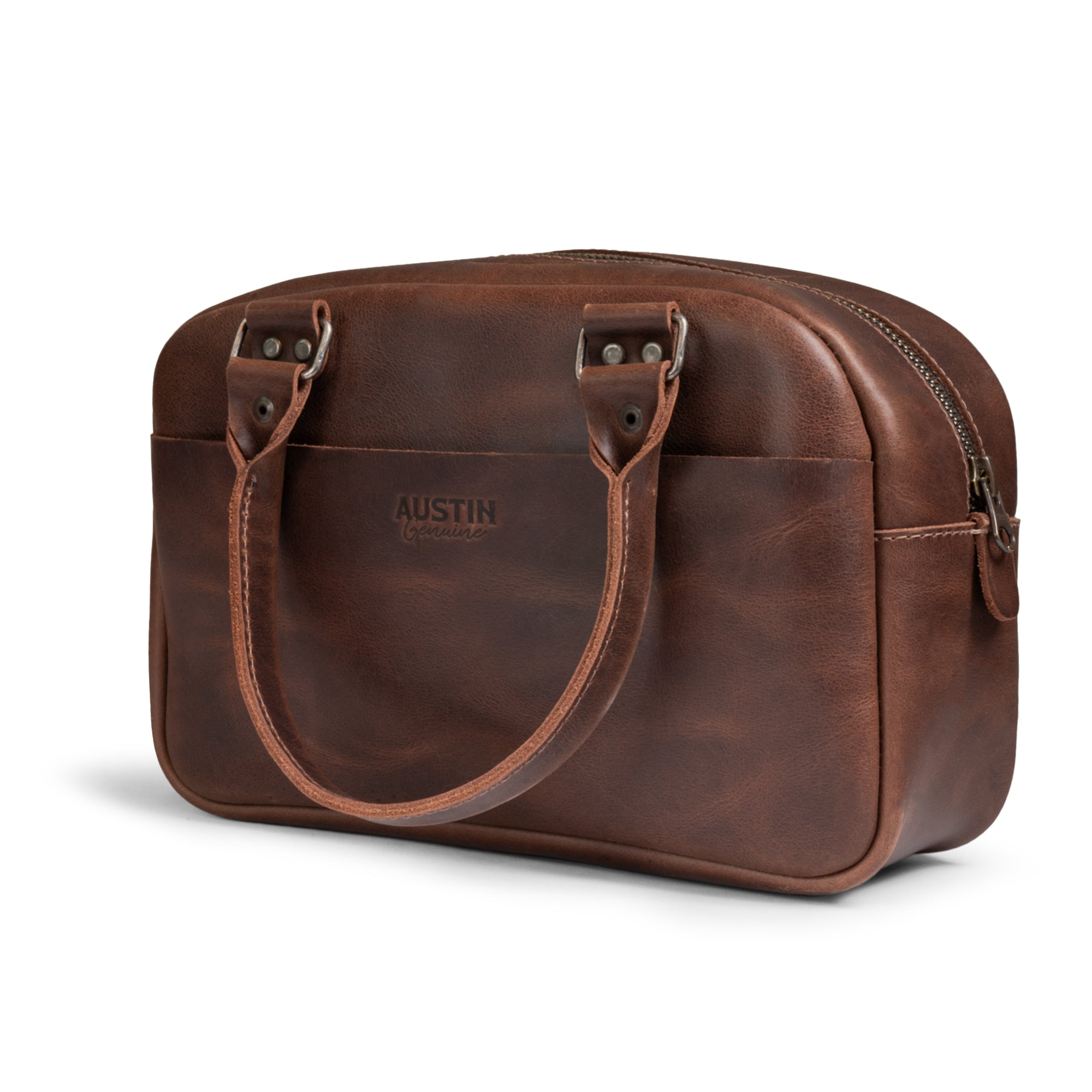 A back perspective of The Rainey Handbag by Austin Genuine which showcases its elegant form and durable Full Grain Leather construction. This handbag embodies Small Batch Production, featuring Hand Cut and Hand Sewn excellence, with a Fire Branded emblem created by artisans in La Antigua Guatemala & Oaxaca Mexico.