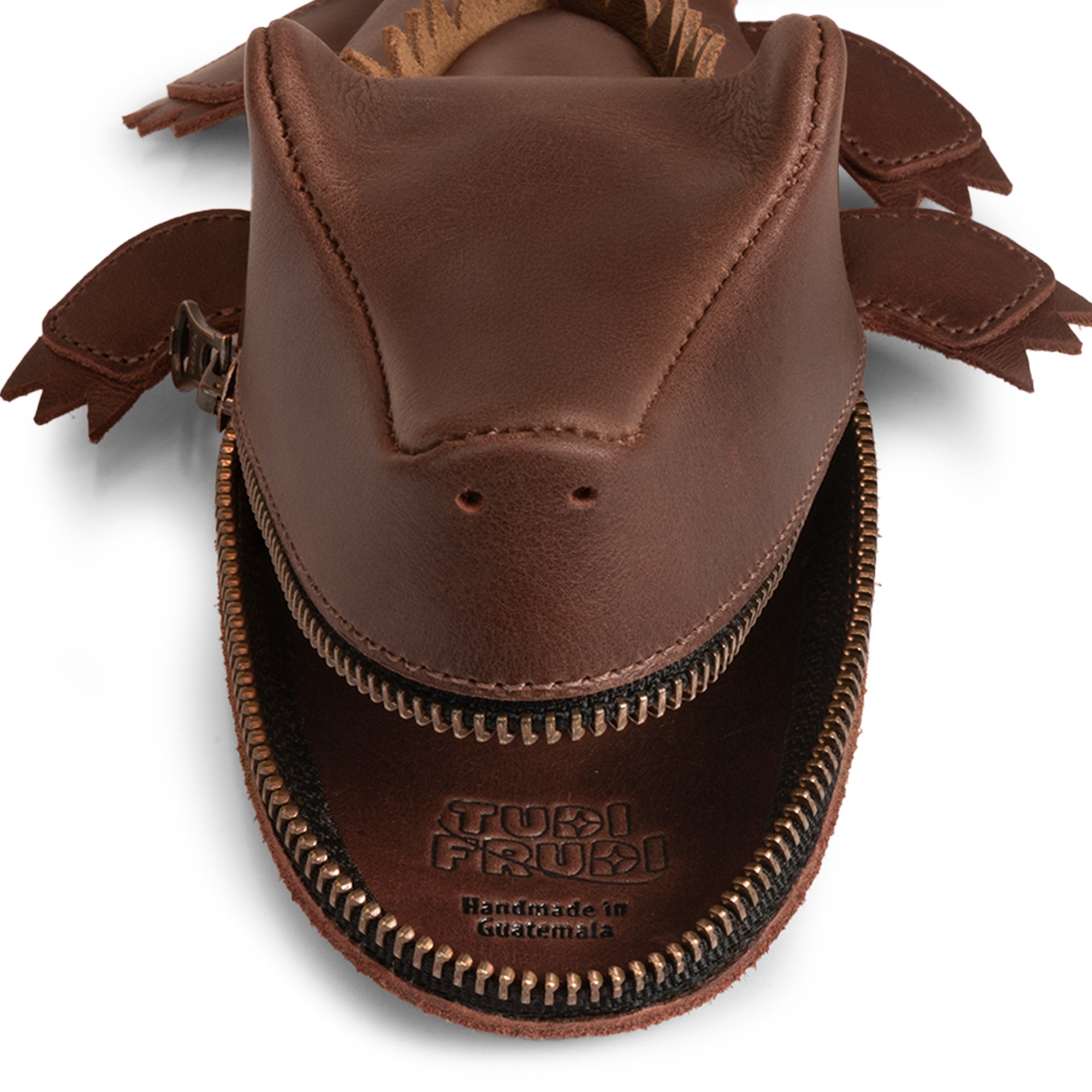 Top view of the Leather Gator Pouch by Tudi Frudi, highlighting its distinctive craftsmanship. This Gator Leather Pouch functions as an alligator-shaped coin purse, small charger cable holder, and is perfect as a change bag or scissors case. Crafted from premium full grain leather with hand cut and sewn precision in small batch production, it embodies artisan quality. Handmade in La Antigua Guatemala & Oaxaca, Mexico, this stylish accessory is an excellent addition to any collection.