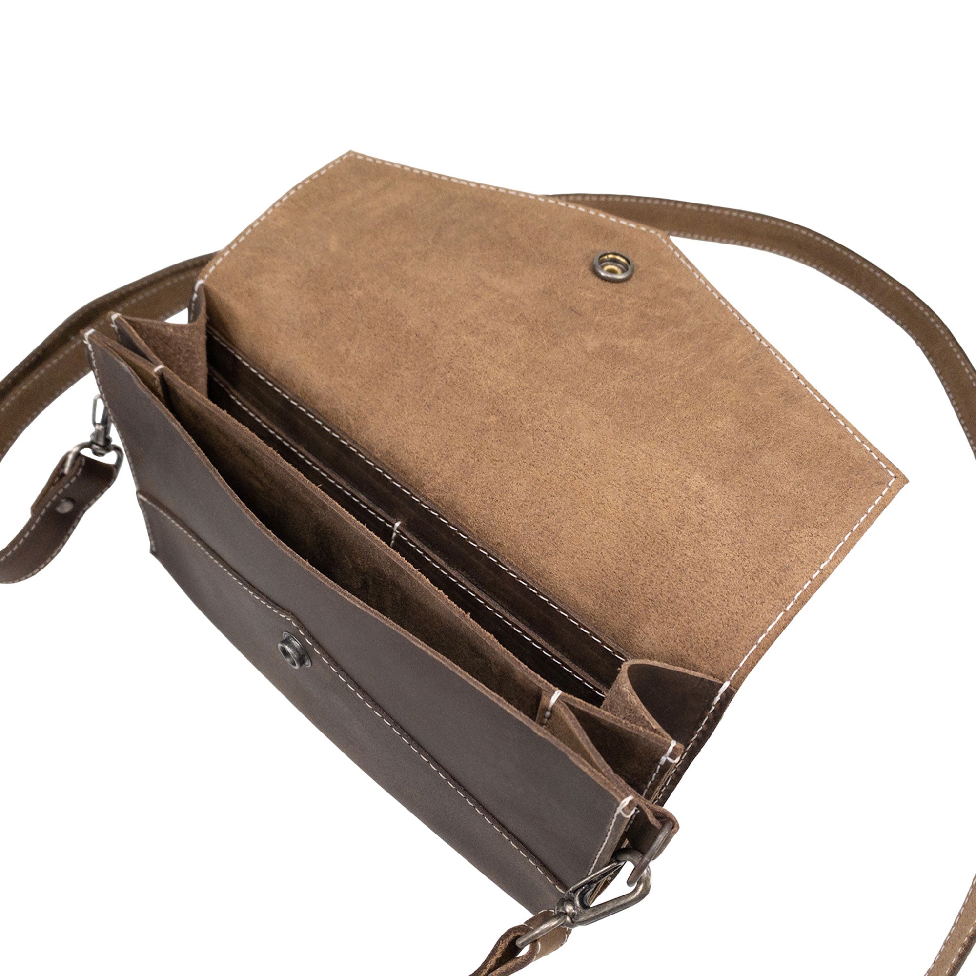 Interior view of the Convertible Envelope Bag by Hide & Drink, revealing the spacious design in premium Full Grain Leather. This Envelope Crossbody Bag exemplifies small batch production with hand cut, hand sewn details, showcasing artisan craftsmanship from La Antigua Guatemala & Oaxaca Mexico.