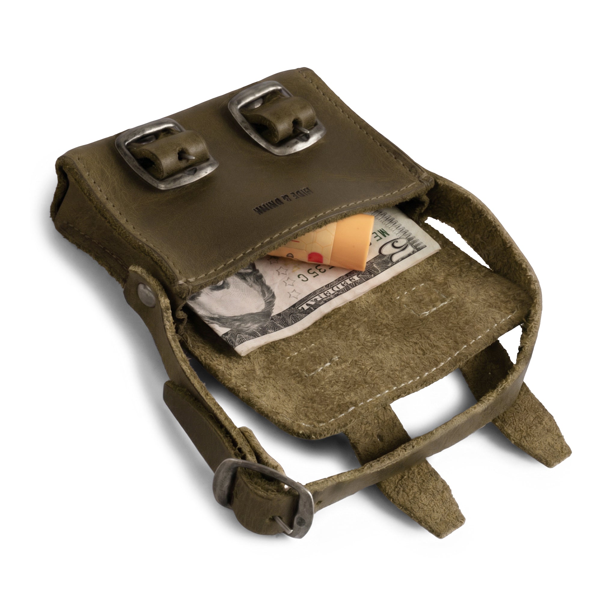 Inside view of the green Tiny Messenger Bag by Hide & Drink, showcasing its compartment for cash and coins. This lovely Mini Messenger Bag Charm made from Full Grain Leather serves as a keychain or handbag ornament, emphasizing artisan craftsmanship from La Antigua Guatemala.