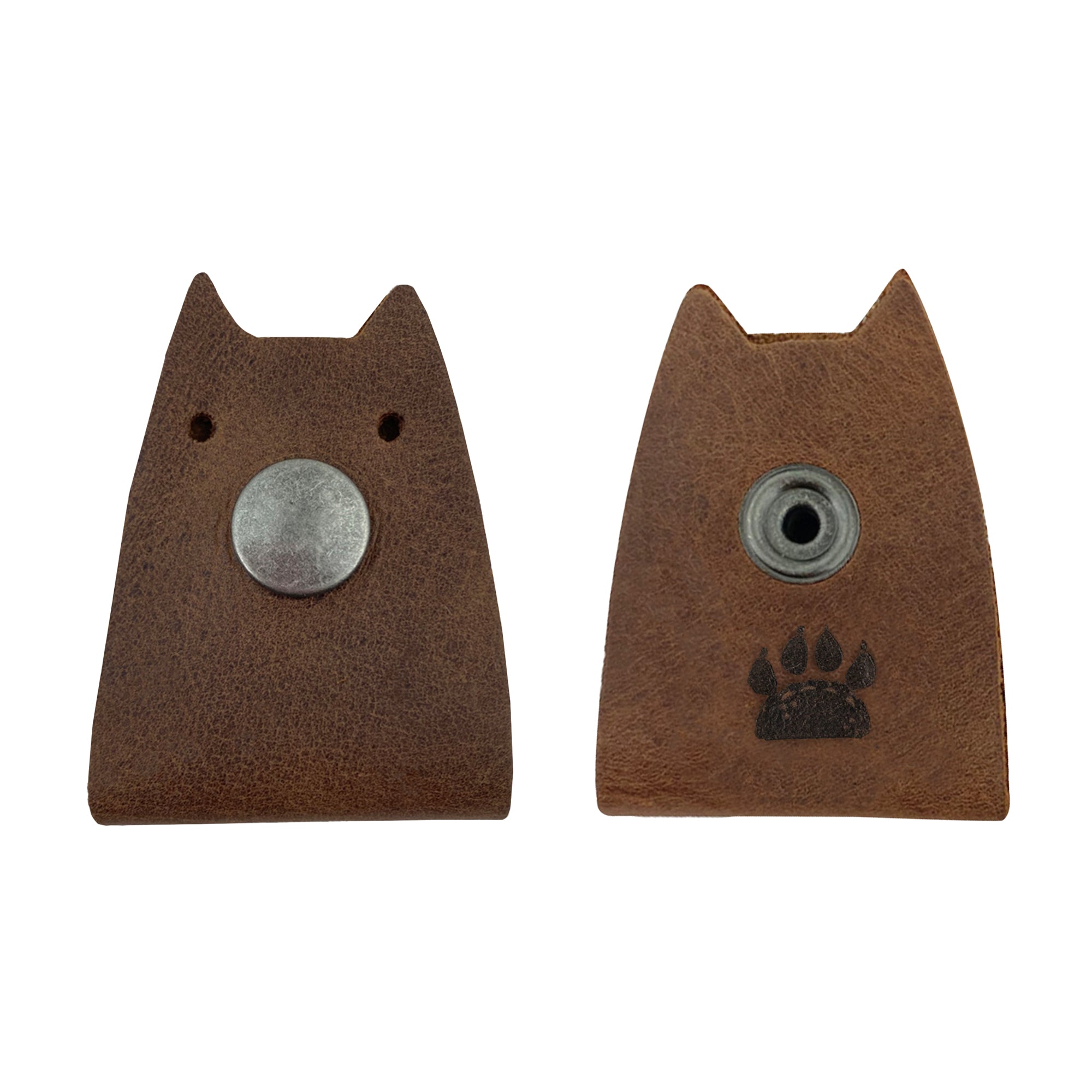Two variations of Taco Dog's Cat Cord Keeper (2 Pack) with snap buttons. Perfect for wrapping up your cables, earbuds, headphones, and chargers. The full grain leather design combines function with style. Clips easily together for travel convenience, and each piece is artisan made in La Antigua Guatemala & Oaxaca Mexico.