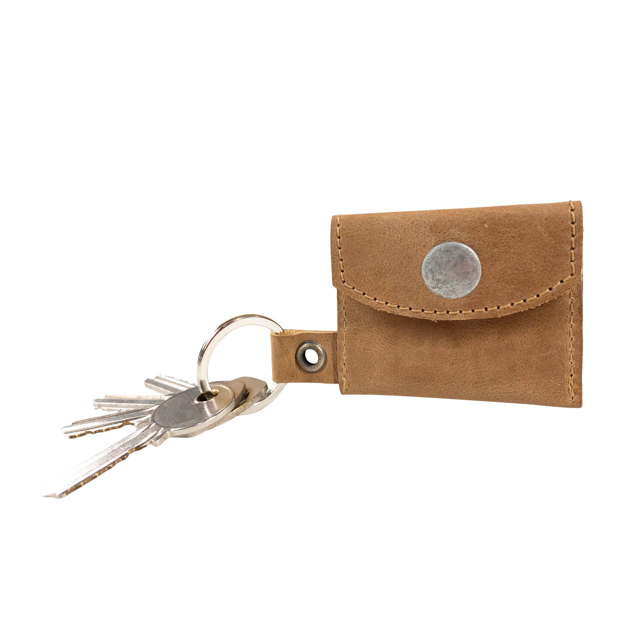 Tiny Coin Holder Keychain by Hide & Drink with accompanying branding. Its premium Full Grain Leather construction symbolizes quality and dedication to artisan craftsmanship in small batch production.