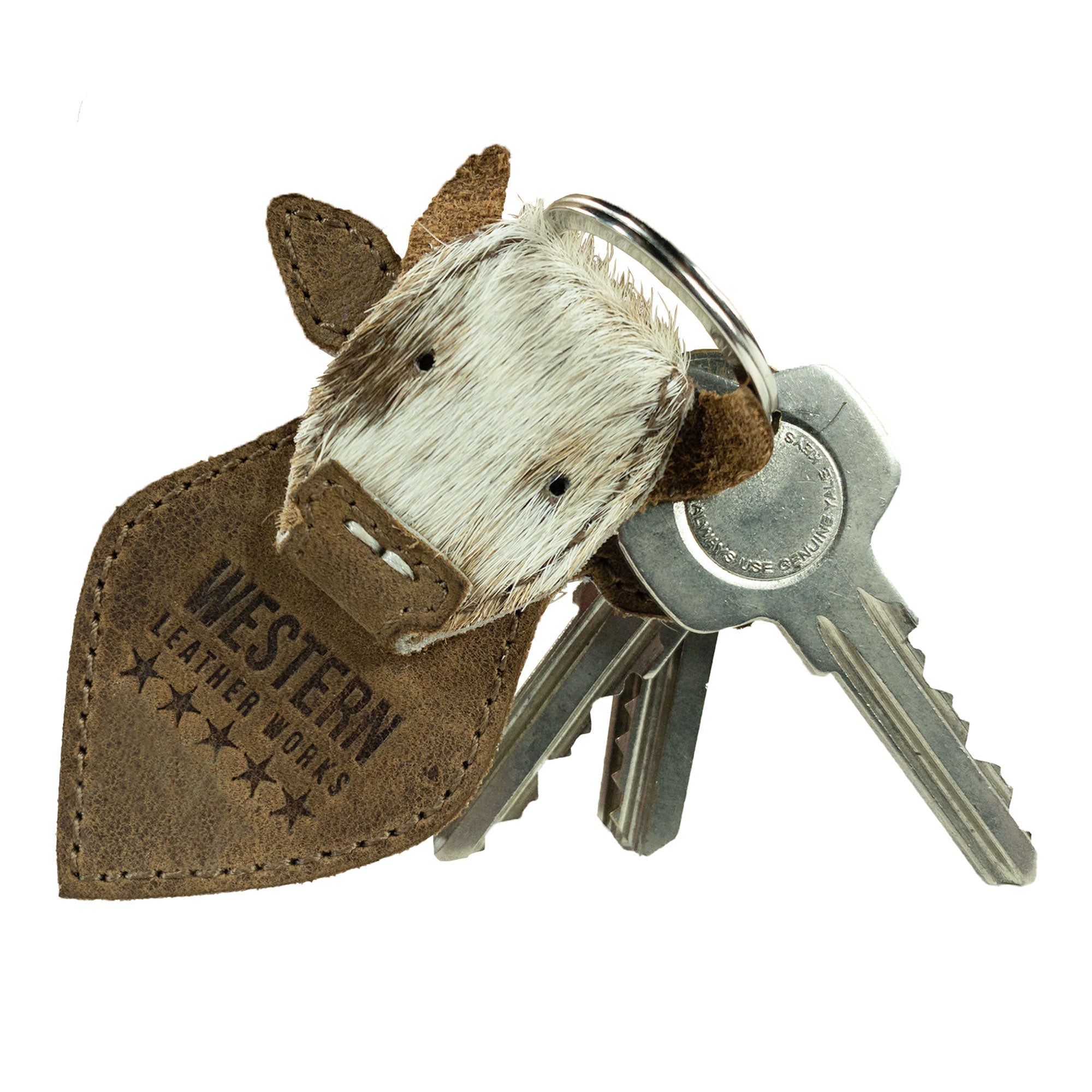 With its rustic charm, the Cow Head Keychain from Western Leather Works doubles as a fashionable key organizer and cowboy style keyring. Hand cut and sewn from durable full grain leather, this artisan piece embodies the unique craftsmanship from La Antigua Guatemala.